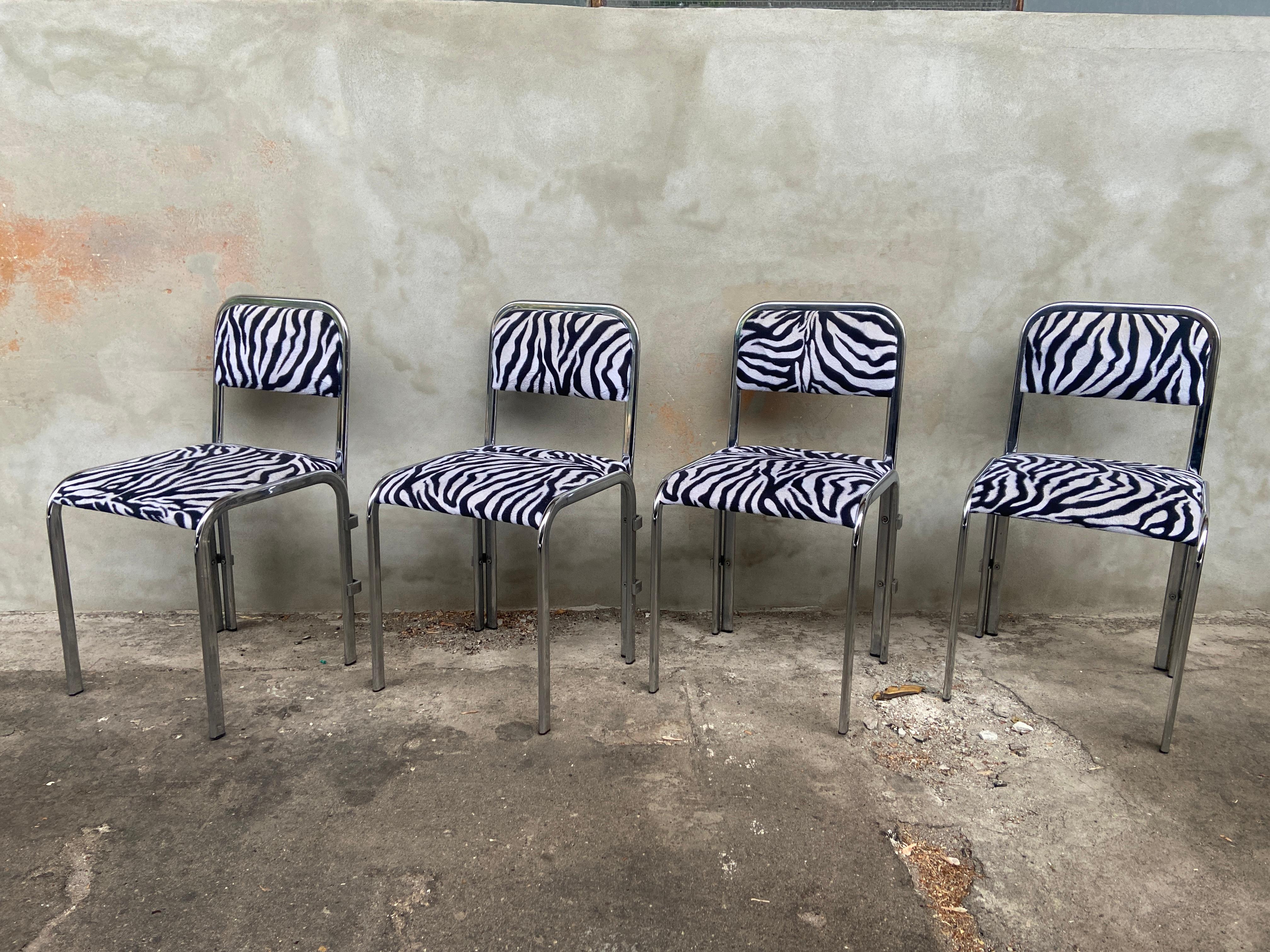 Mid-Century Modern French set of four chrome dining room chairs covered with its original zebra fabric. 1970s
The set is in really good vintage conditions with a beautiful patina due to age and use.
These chairs can come a complete dining room set