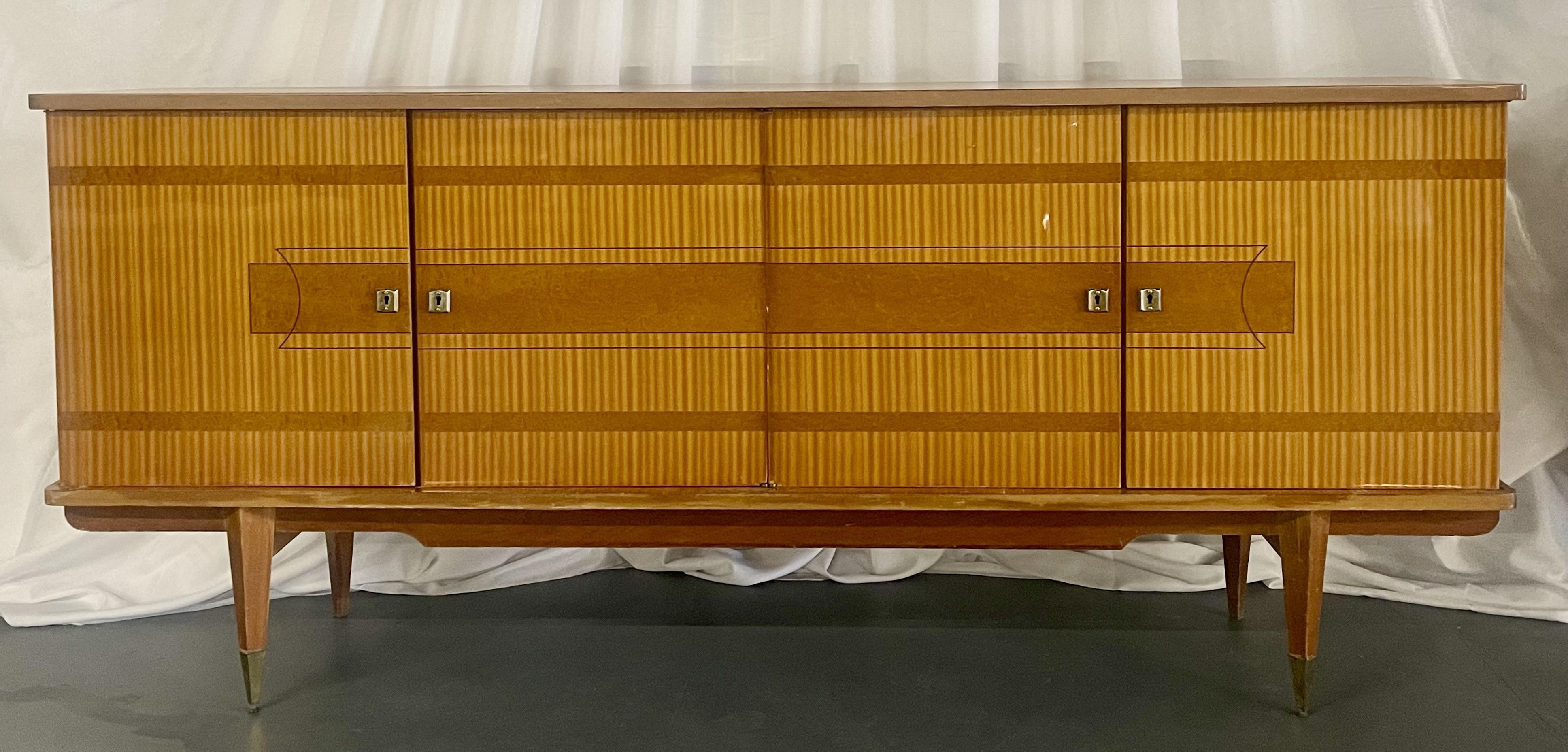 A French Cuban Mahogany Sideboard, Credenza or Buffet having four doors leading to a shelved finely fitted interior of sycamore. This large and impressive cabinet is simply stunning having long sleek tapering angled legs leading to an interior fully