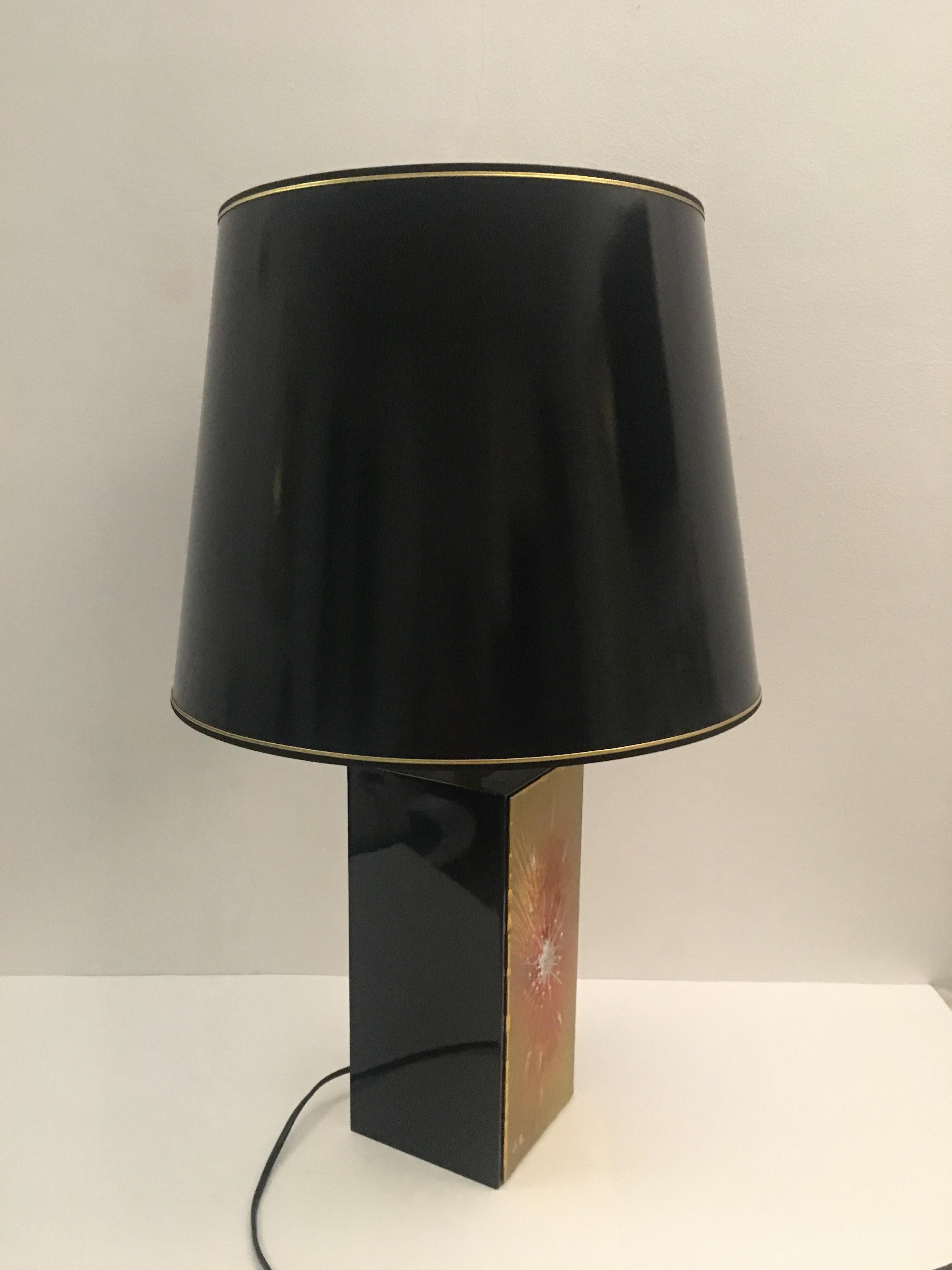 Midcentury table lamp from the 1970s, Signed J.G. and presumably from Vallauris, France. 
The square metal multicolored base combined with the classical shade trimmed in gold has many very attractive details which give this lamp its' modern and