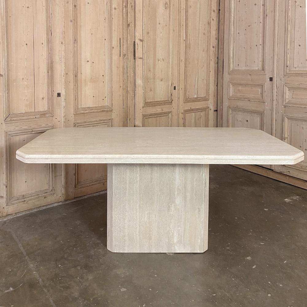 Mid-Century Modern French Travertine dining table is the essence of tailored elegance, with a carefree aspect that is incomparable! The solid stone top requires no apron providing extra leg room, and the base is fully recessed on all sides which