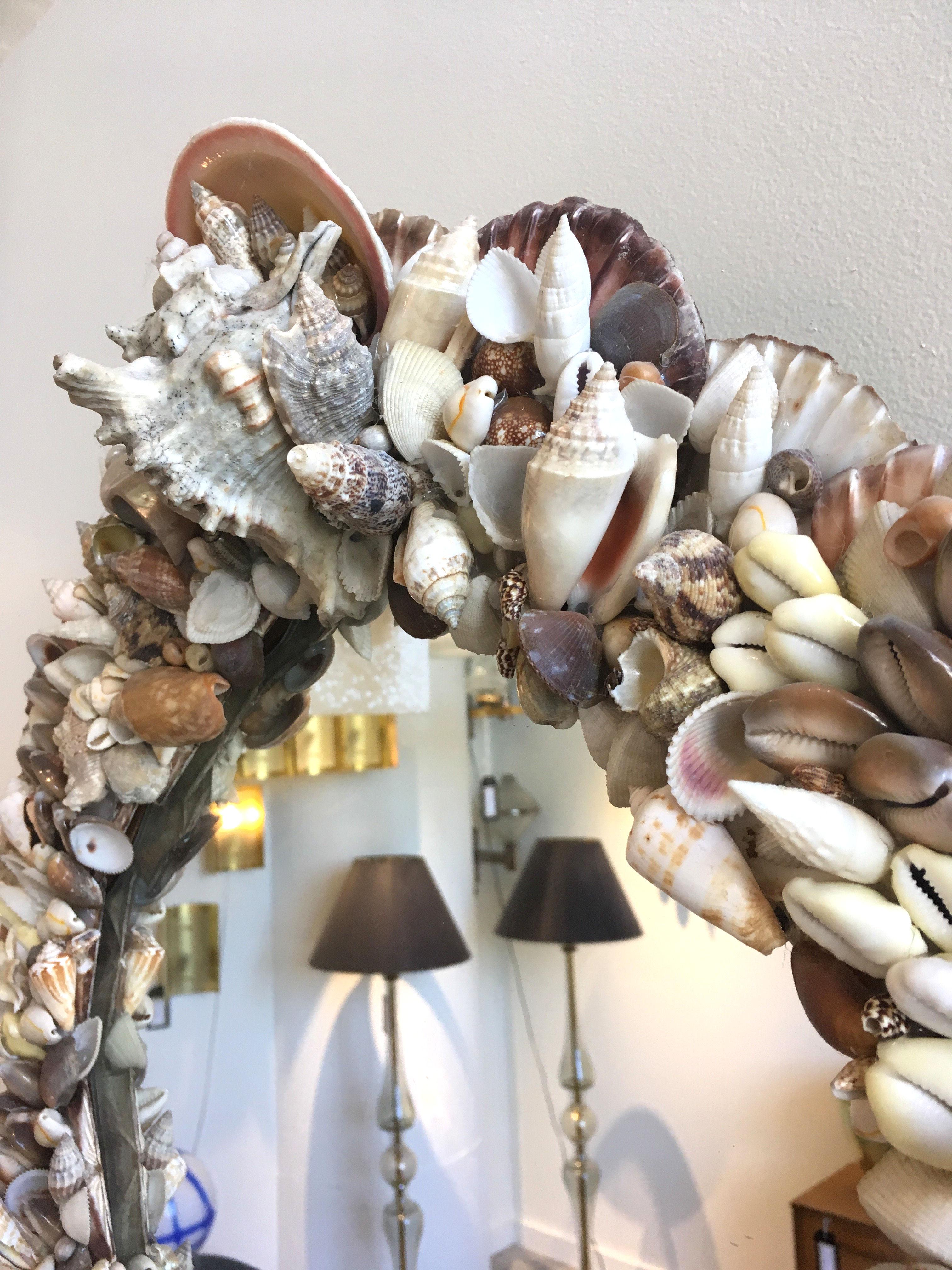 Mid-Century Modern mirror adorned with shells. 
Highly detailed and in excellent condition. 
Every part of the frame has been meticulously covered in layers of beautiful seashells, 1970s, La Baule, France.