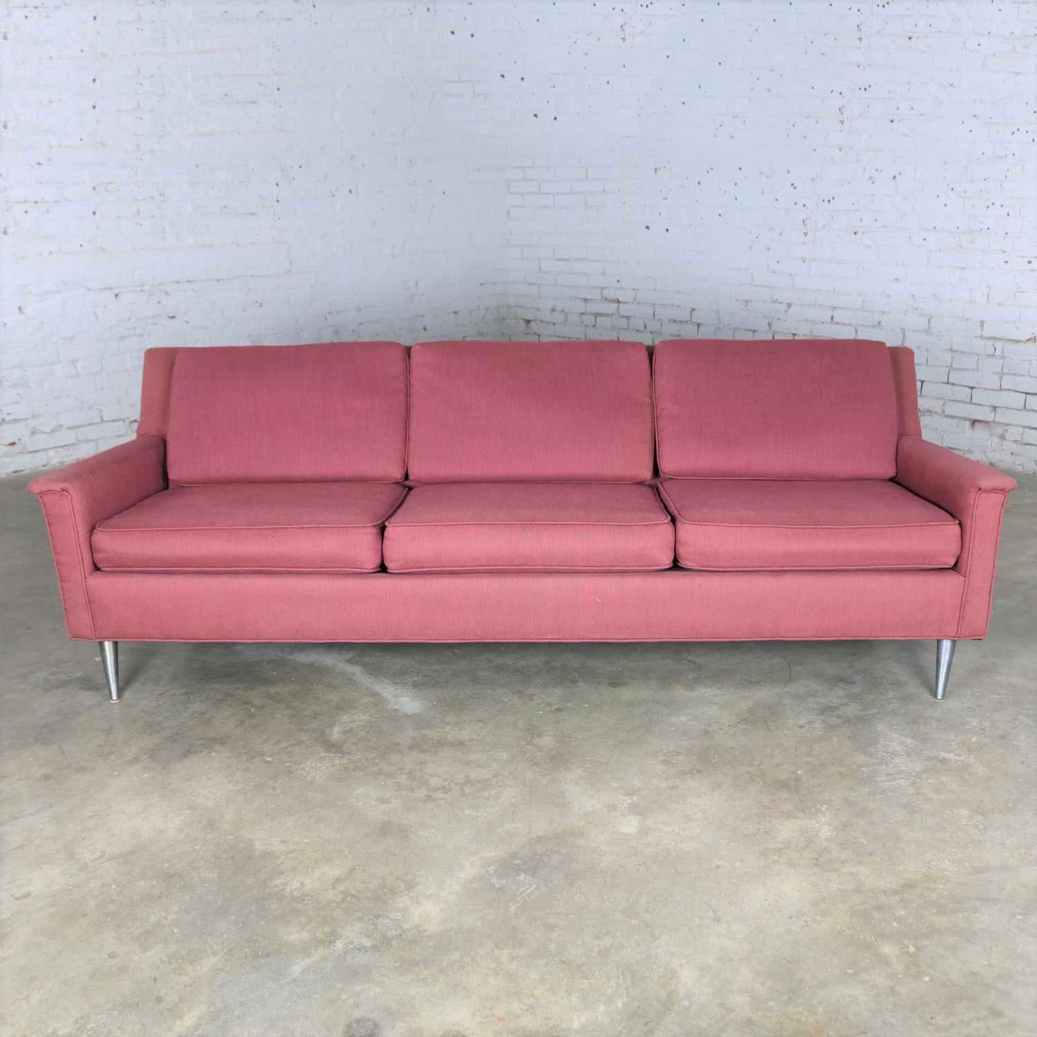 Fabulous Mid-Century Modern fuchsia sofa with awesome silver colored turned metal tapered legs. It is done in the style of the great Edward Wormley for his work done for Dunbar. It is in wonderful vintage condition. It has been recovered and looks