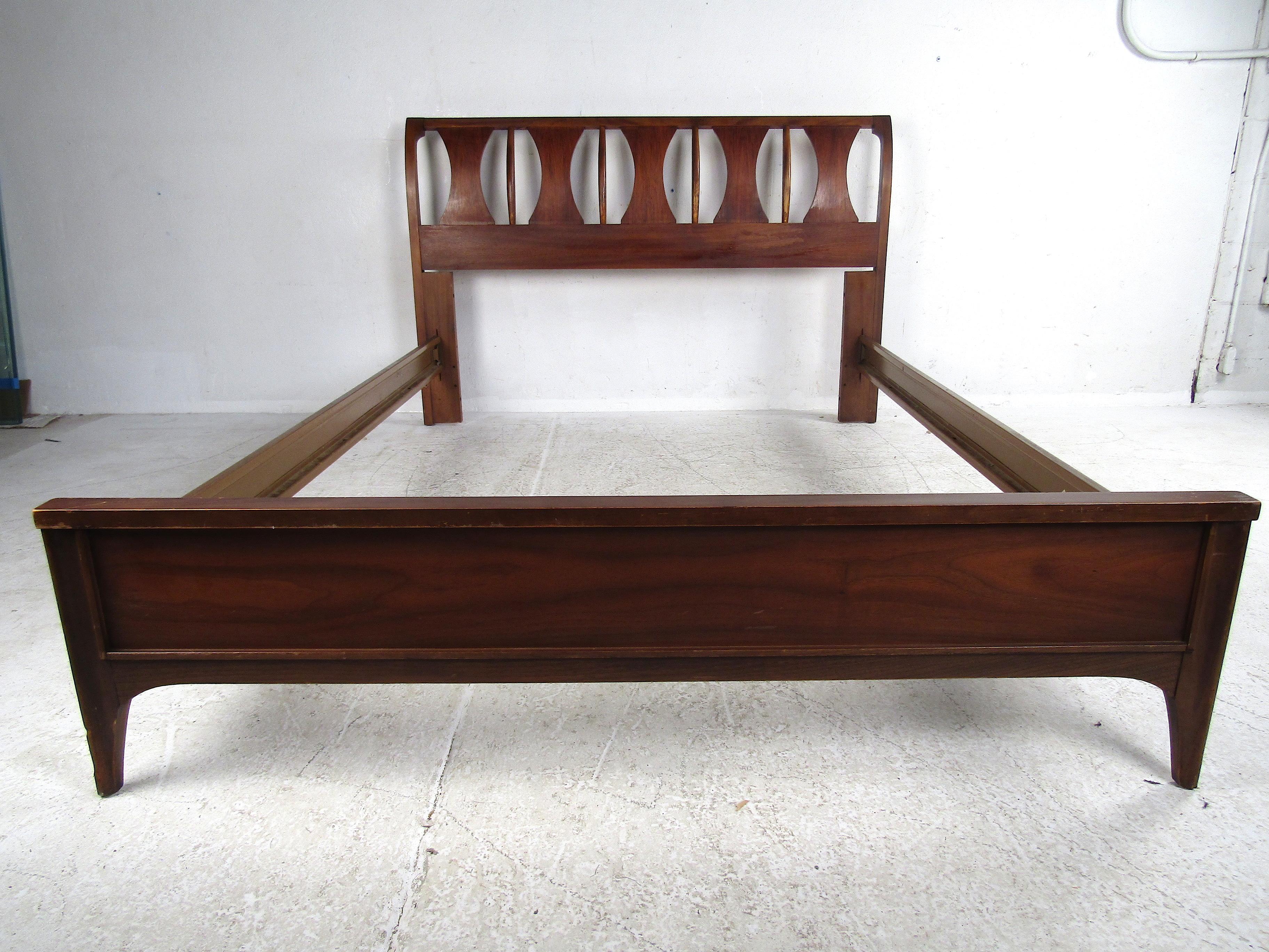 Great Mid-Century Modern bedframe. Stylish accents spanning the headboard along with a low-profile footboard give this piece a nice look. Striking mixture of walnut and rosewood, and metal rails with a mock wood-grain pattern. Sure to be a great