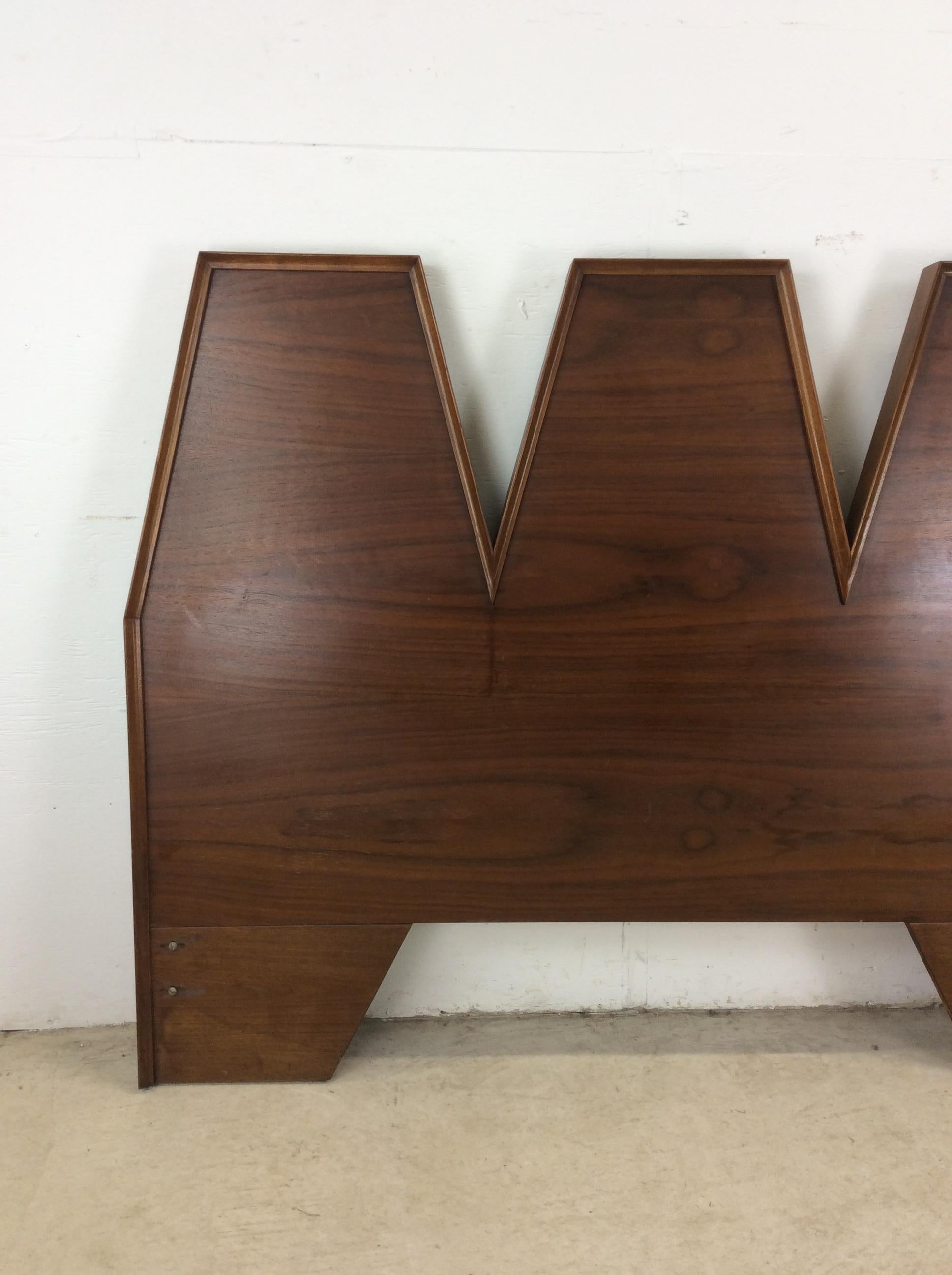 This mid century modern full size headboard by Albert Parvin for American of Martinsville features hardwood construction, beautiful walnut veneer with original finish, two bolts where it can be affixed to a bed frame.   Matching lowboy dresser,