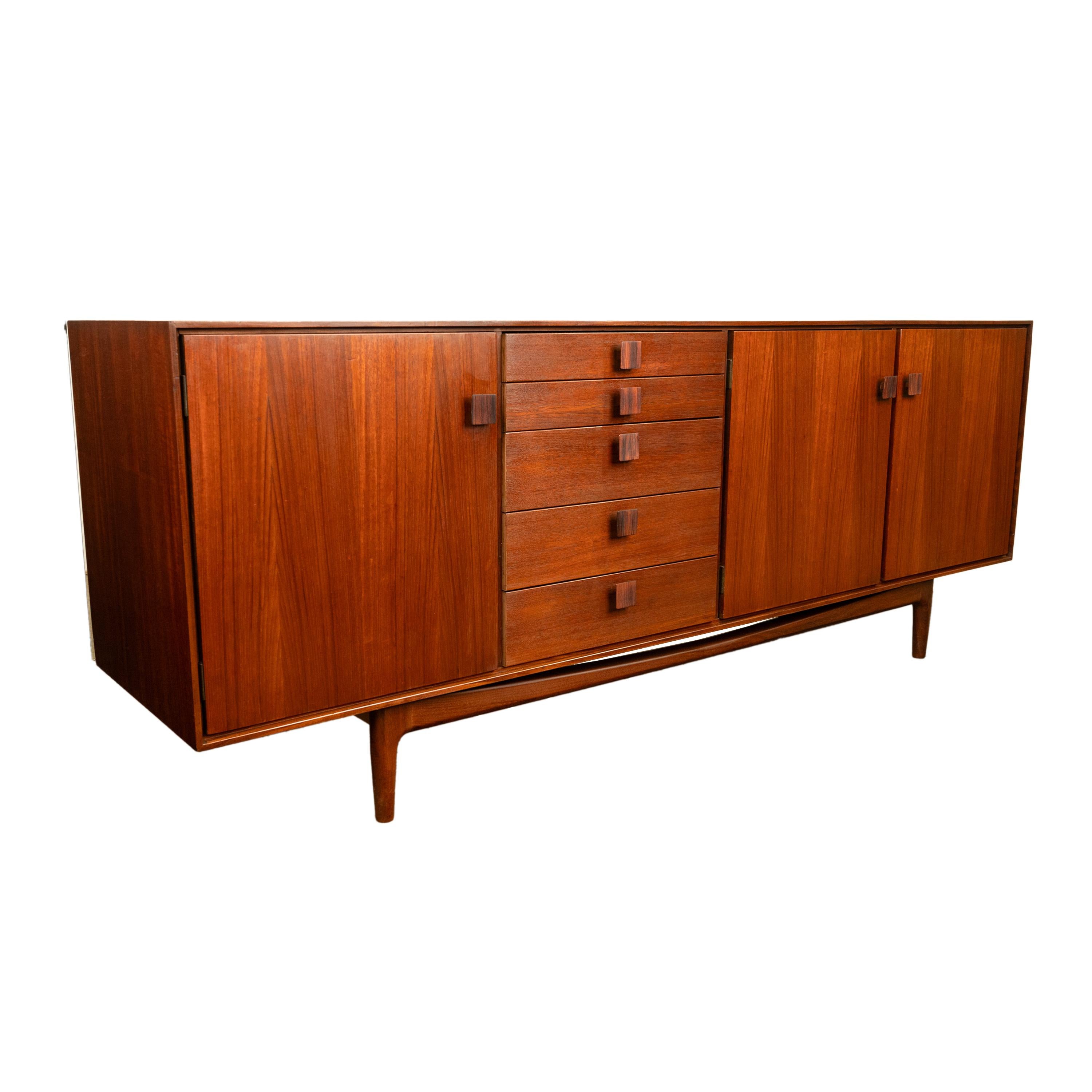 A very good original Mid Century Modern teak Credenza designed by IB Kofod Larsen, for G Plan's Danish range in 1965.
The credenza is the longer of two designs this one having three doors and a bank of five graduated drawers, there was also a