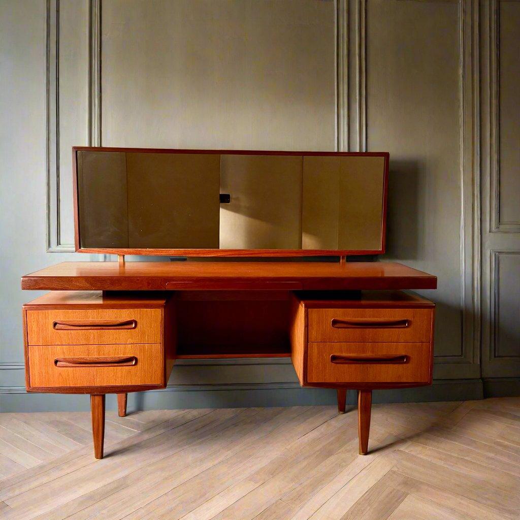 Discover the Timeless Elegance of the Mid-Century Modern G-Plan Fresco Floating Top Vanity Desk by Victor Wilkins

Unveiling a masterpiece of Mid-Century Modern design, this G-Plan Fresco teak vanity desk is a stunning example of the era's iconic