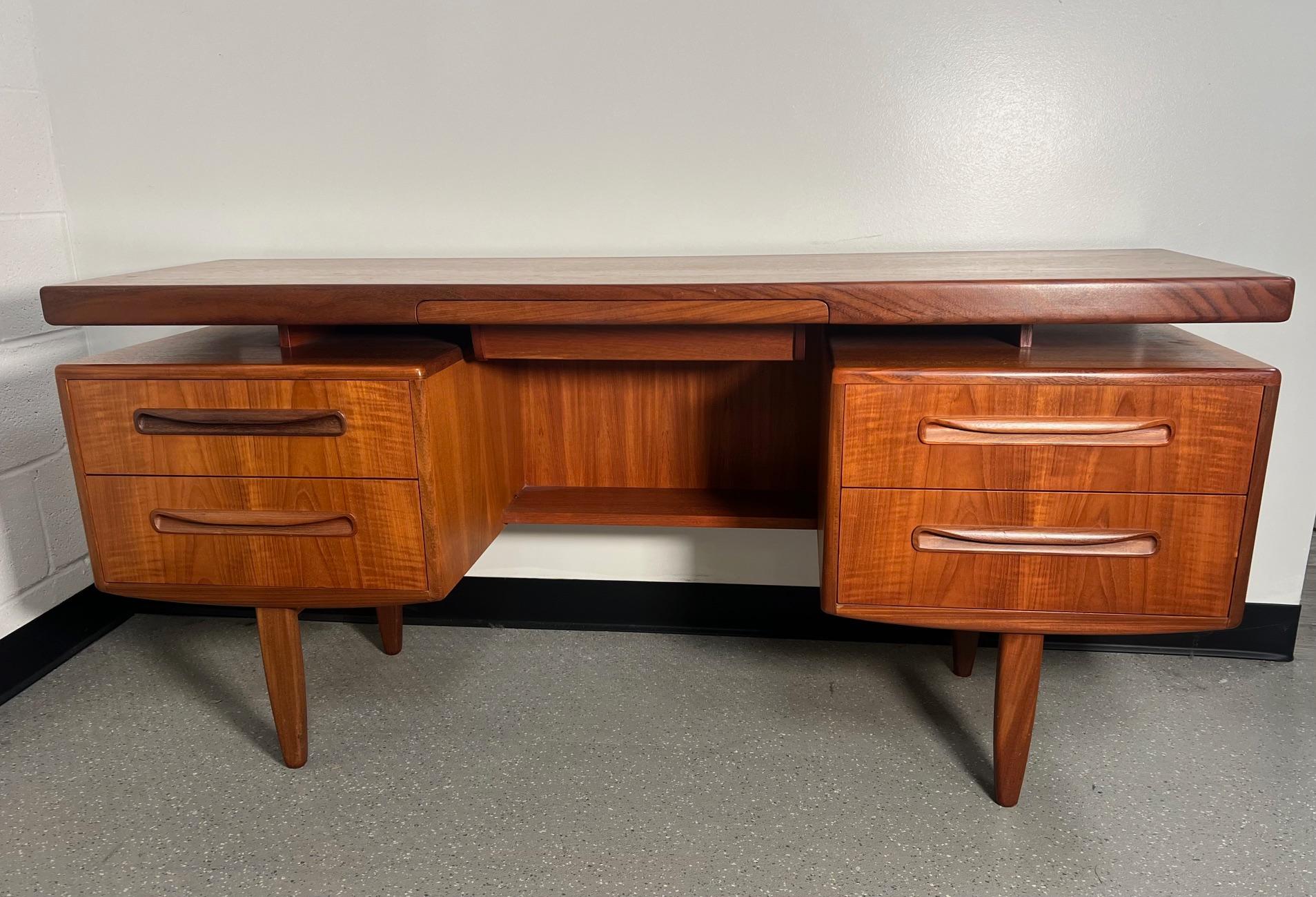 Fantastic mid-century teak vanity or desk.
Designed in the 60s by Victor Bramwell Wilkins for G Plan's Fresco Range. Danish Modern in style. Secret drawer has original purple fabric. Gorgeous continuous grain pattern on the front of the drawers.