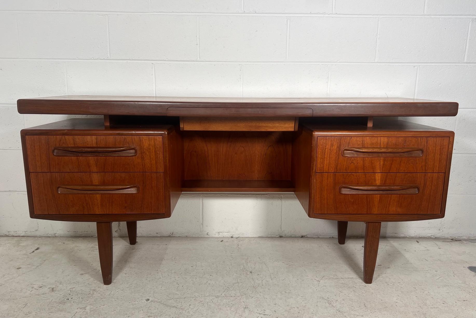 Fantastic mid-century teak vanity or desk. Designed in the 60s by Victor Bramwell Wilkins for G Plan's Fresco Range. Danish Modern in style. Secret drawer has original black fabric. Gorgeous continuous grain pattern on the front of the drawers.