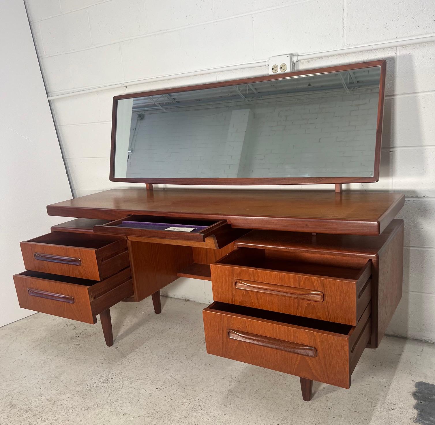 Fantastic mid-century teak vanity with stool. Designed in the 60s by Victor Bramwell Wilkins for G Plan's Fresco Range. Secret drawer has original purple fabric. Gorgeous continuous grain pattern on the front of the drawers. Original G Plan sticker