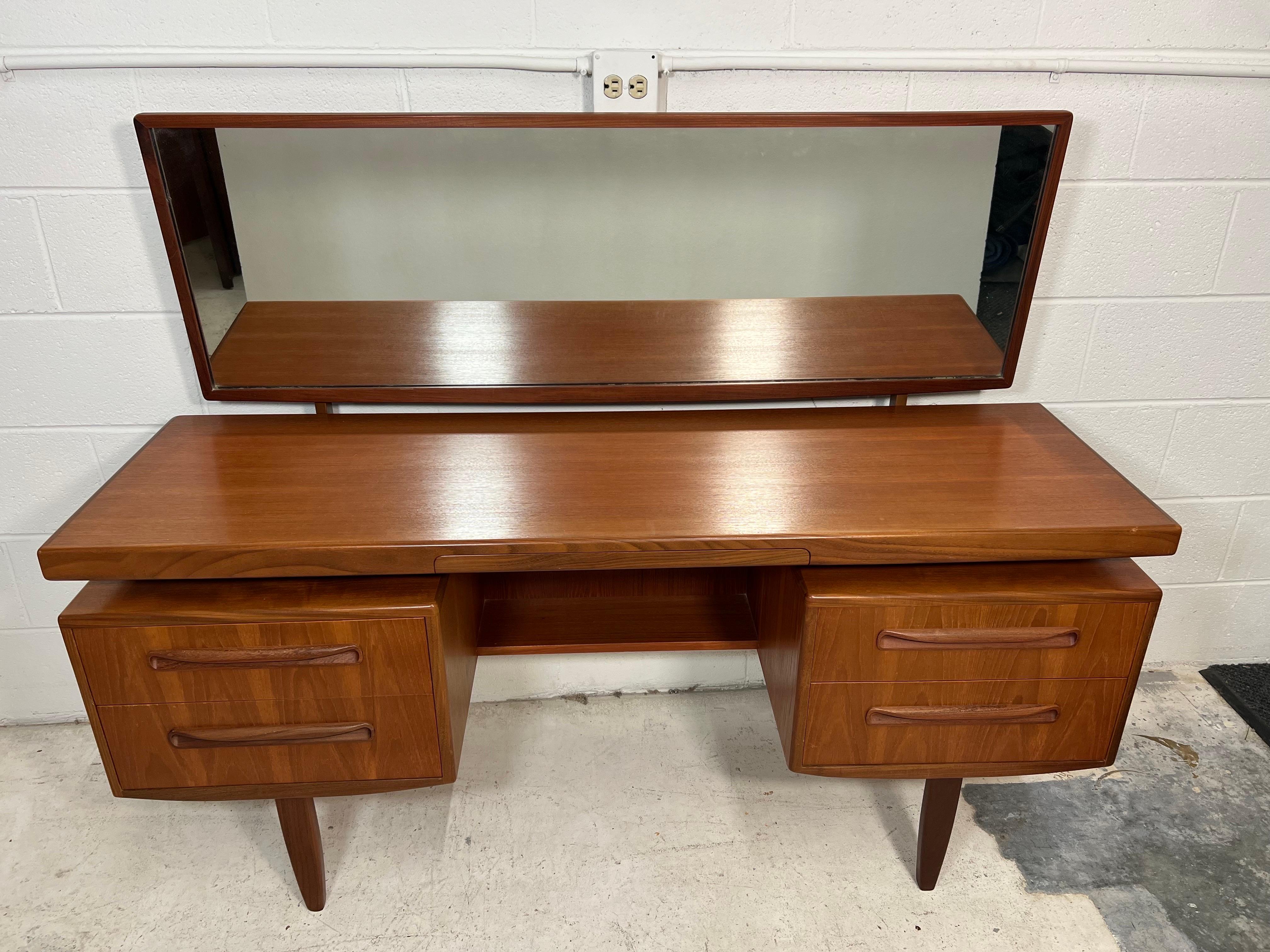 Fantastic mid-century teak vanity with stool. Designed in the 60s by Victor Bramwell Wilkins for G Plan's Fresco Range. Danish Modern in style. Secret drawer has original black fabric. Gorgeous continuous grain pattern on the front of the drawers.