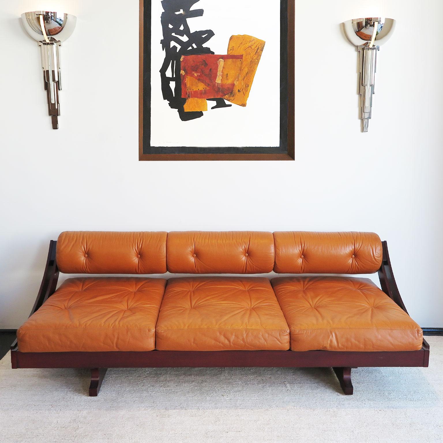 Mid-Century Modern daybed sofa by G. Songia from Italy, circa 1965. Rosewood frame with original aged cognac leather. Tufted seat and back bolster cushions. Original condition.
Bio: Rivista dell'Arredamento Nr. 132 (Dec. 1965).