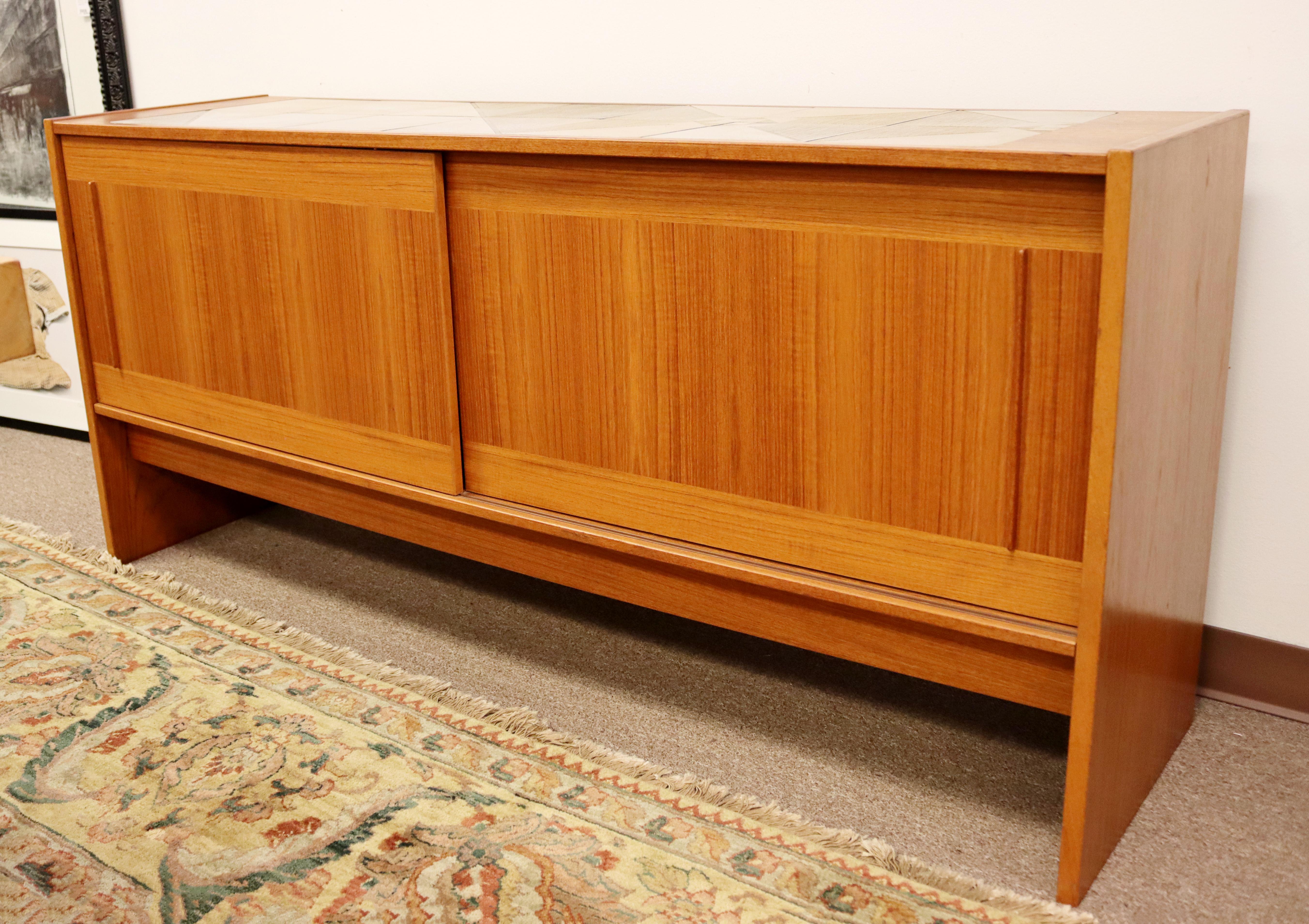 For your consideration is a marvelous, tile top credenza, made of teak and with sliding doors, by Gangso Mobler, made in Denmark, circa the 1970s. In excellent vintage condition. The dimensions are 66.5