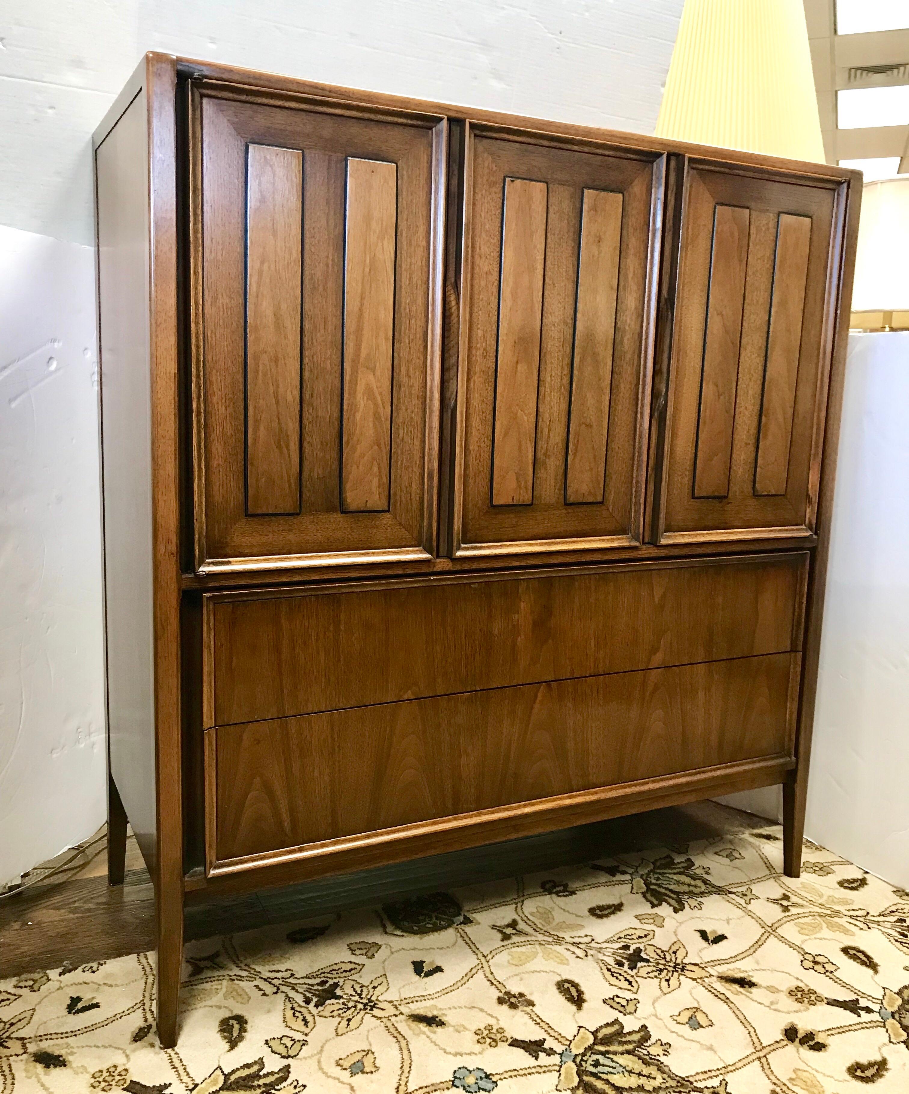 Stunning walnut Classic Thomasville tall wardrobe chest of drawers. Features five drawers in total with the top three hidden behind gorgeous left side folding doors. We will also be listing a companion chest of drawers this week that matches.