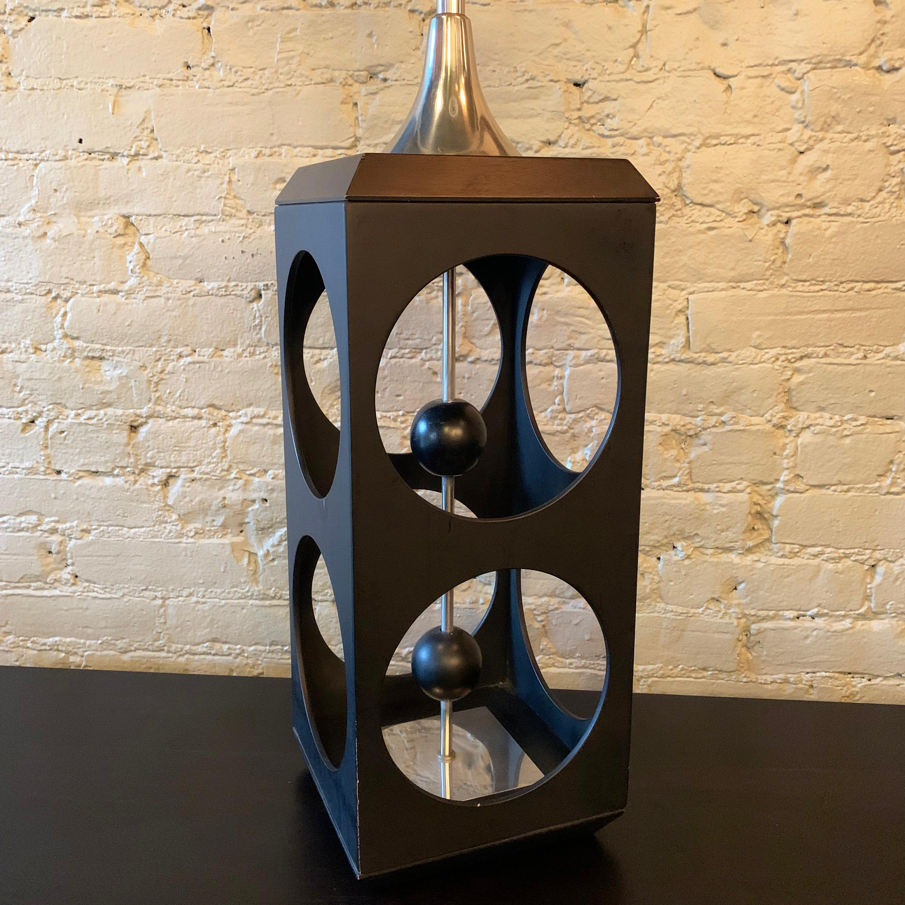 Large, Mid-Century Modern, black laminate wood, geometric, cube-shape, cut-out, table lamp features chrome hardware with a pull chain switch that runs along it's core. The height to the lamp's socket is 28 inches.