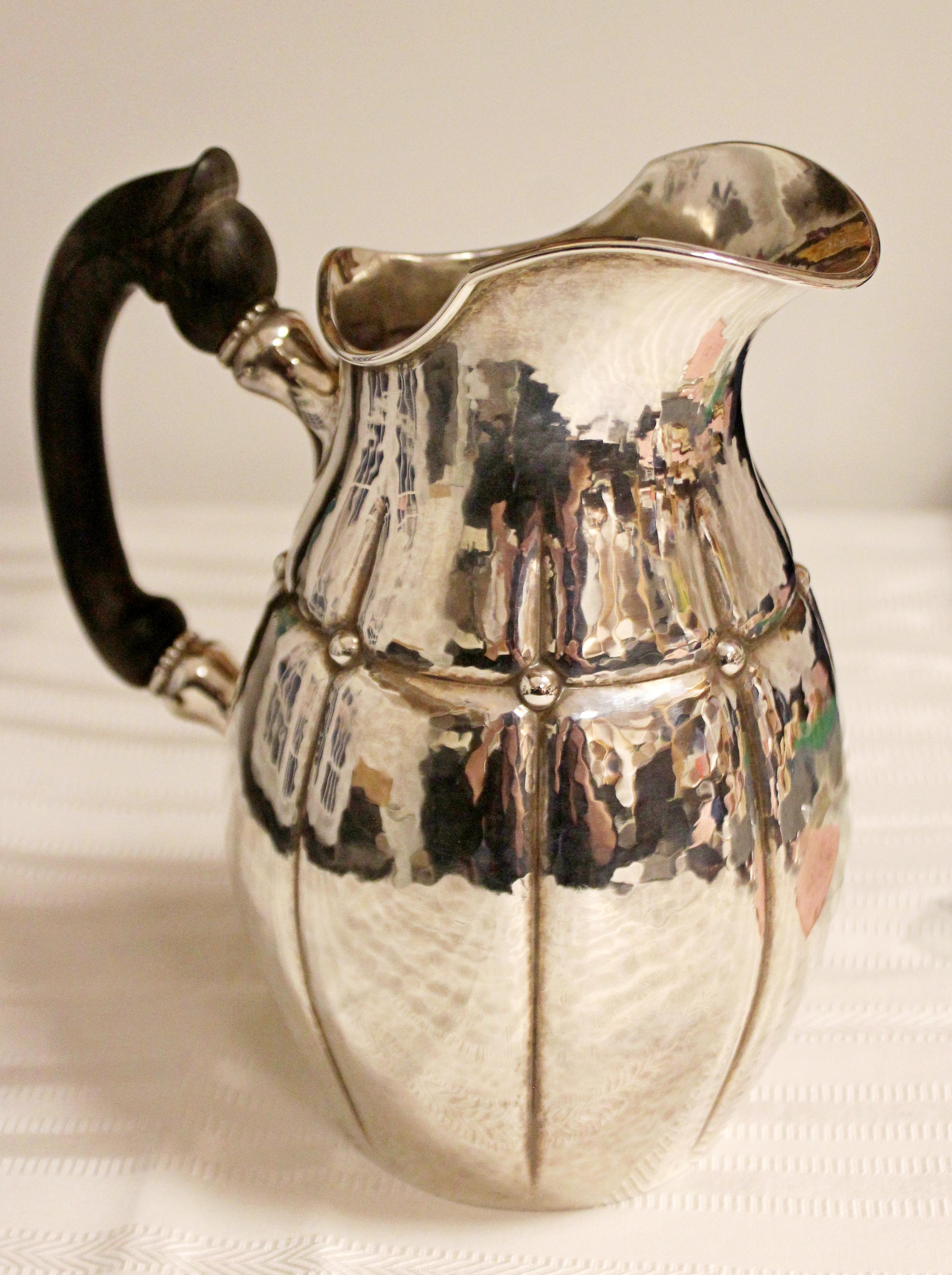 For your consideration is a stunning rare early silver pitcher, Carl Cohr in the style of Georg Jensen,  with a wood handle, stamped, made in Denmark. In excellent condition. The dimensions are 6.75