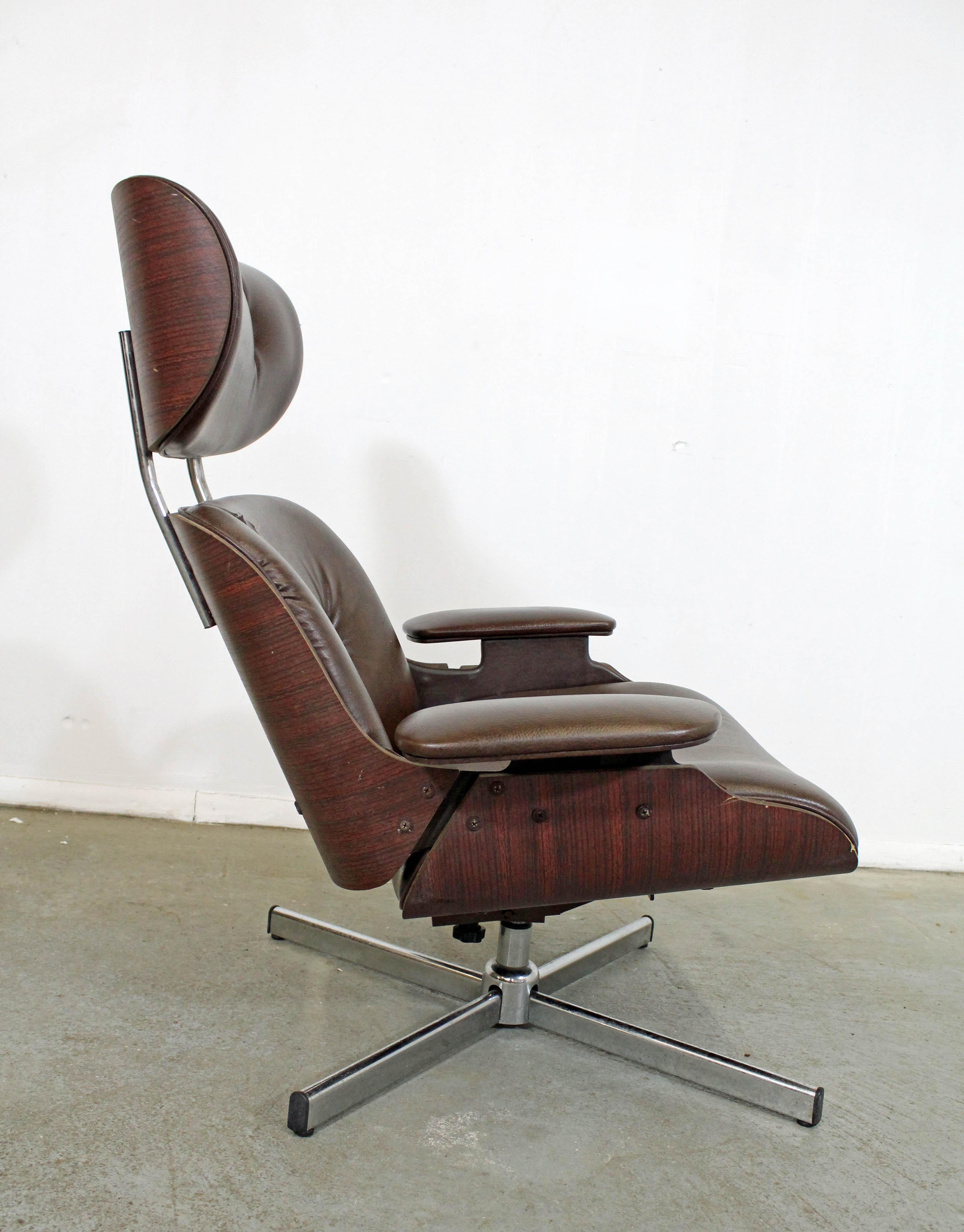 What a find. Offered is vintage swivel lounge chair with vinyl upholstery and a walnut back shell, designed by George Mulhauser for Plycraft. It is in decent condition, but has noticeable wear and needs some restoration (small tears, chair missing a