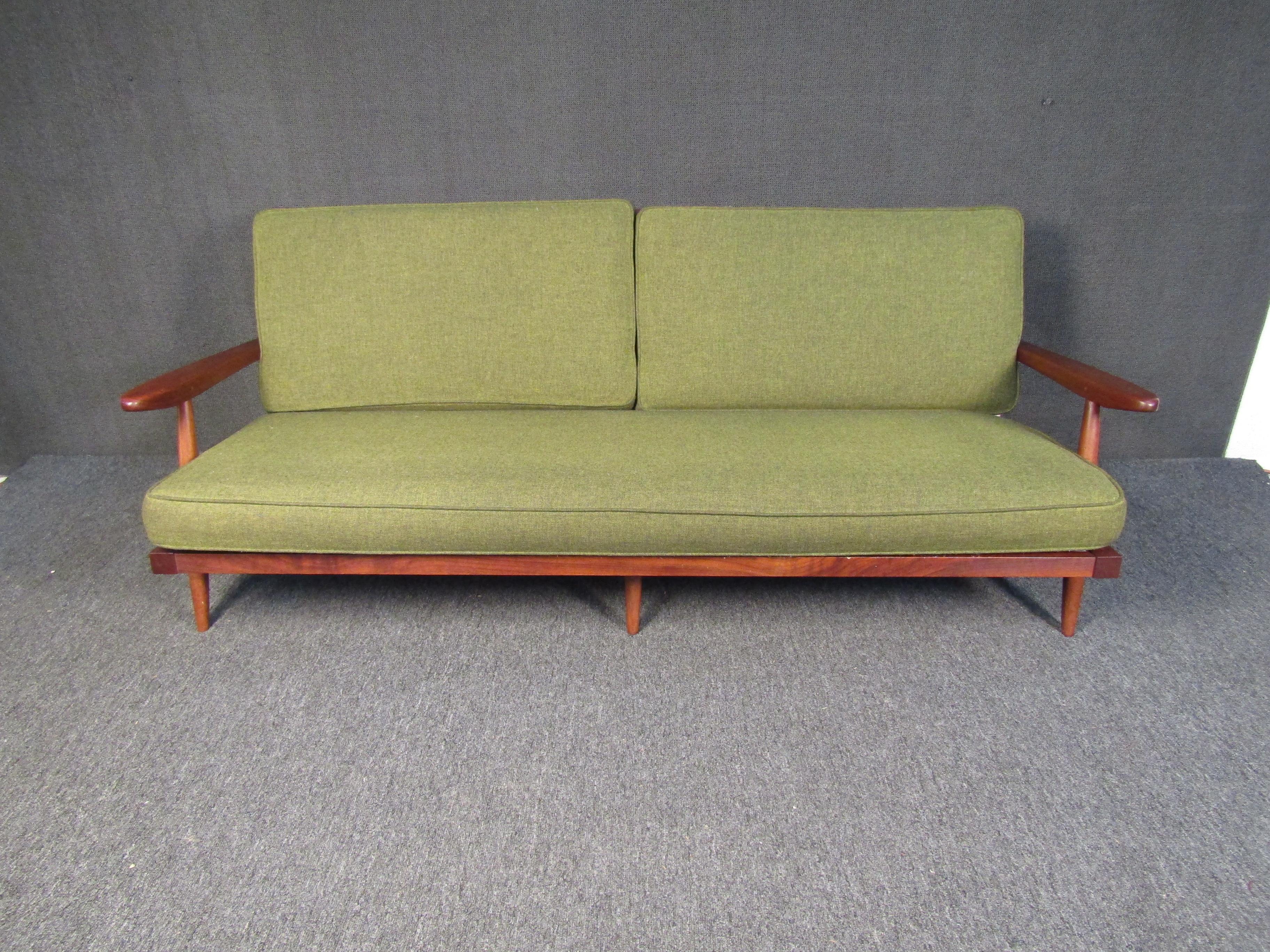 Original George Nakashima walnut sofa featuring an angled slat back, tapered legs, cushioned backrest and seat.
This item includes a letter of authentification from Nakashima Studios signed by Mira Nakashima.

Please confirm item location (NY or