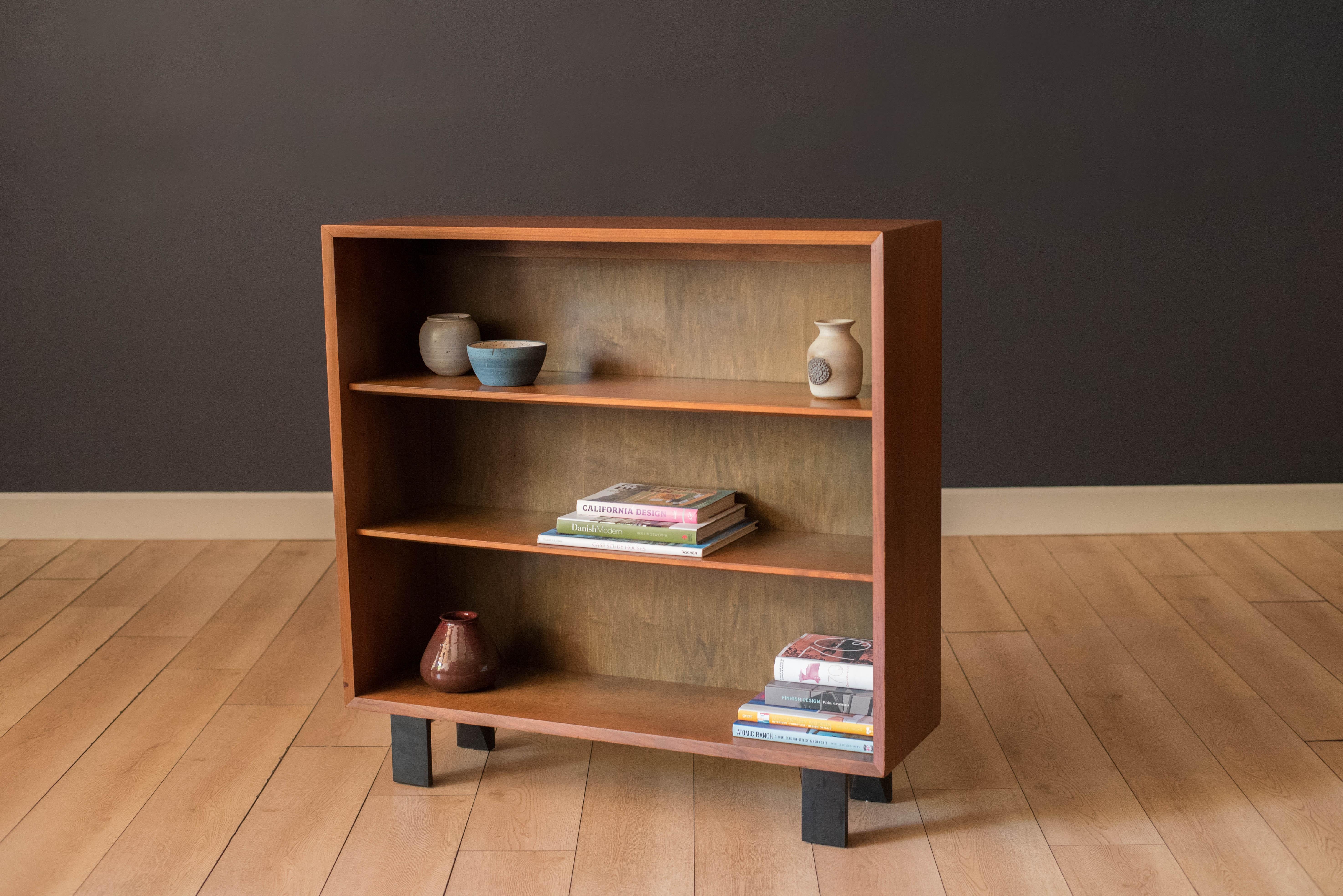 Vintage display bookcase designed by George Nelson for Herman Miller in walnut, circa 1950s. This piece is part of the Basic Cabinet Series (BCS) that offers plenty of open storage including three tiers of shelving in maple wood. This simple and