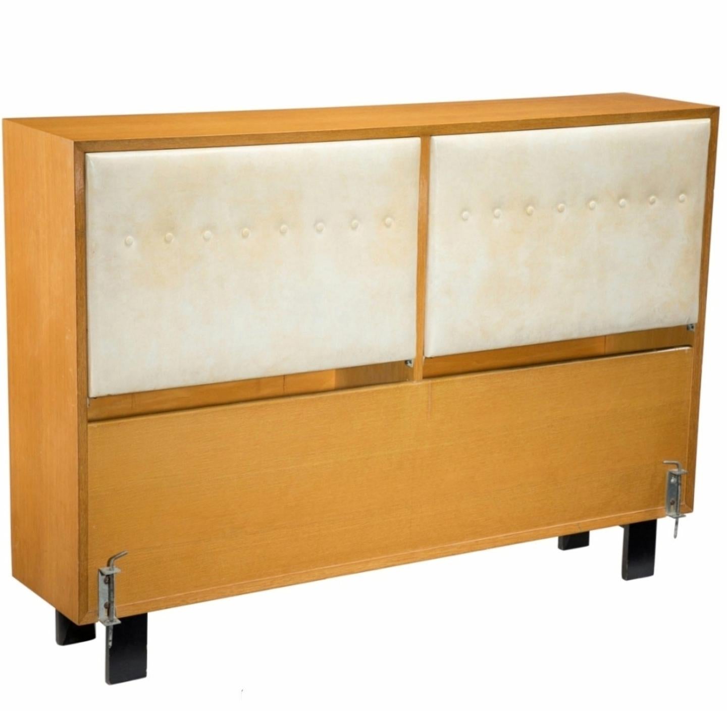 A rare American Mid-Century Modern headboard for a double (full) size bed with storage and adjustable backrests by important Modernist architect and designer George Nelson (American, 1908-1986) for Herman Miller, circa 1950, model 4647 from the