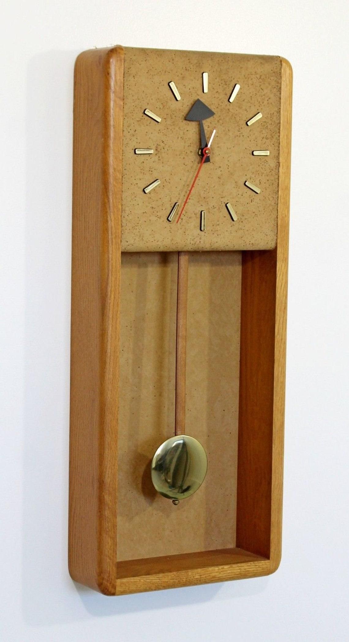 For your consideration is an excellent, George Nelson for Howard Miller mantle or hanging grandfather clock, with brass face and pendulum, made at the famous Zeeland Michigan plant, circa the 1960s 1970s. In excellent condition, and keeps perfect