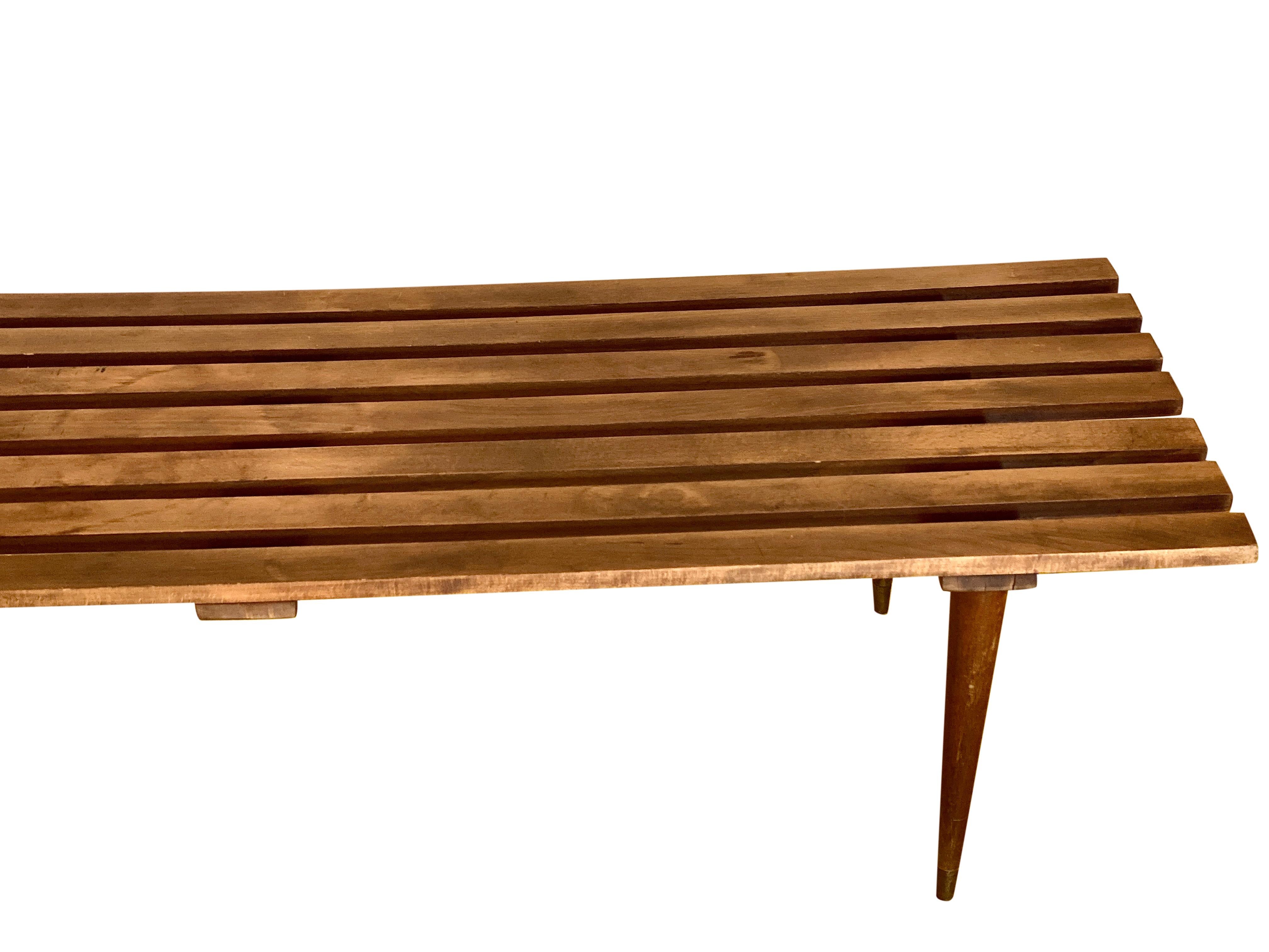 Beautiful, long, slat Mid-Century Modern bench/coffee table in the manner of George Nelson. In great vintage condition with light, age-appropriate wear throughout. Incredibly solid and sturdy. A wonderful piece that belongs in any stylish home.

 