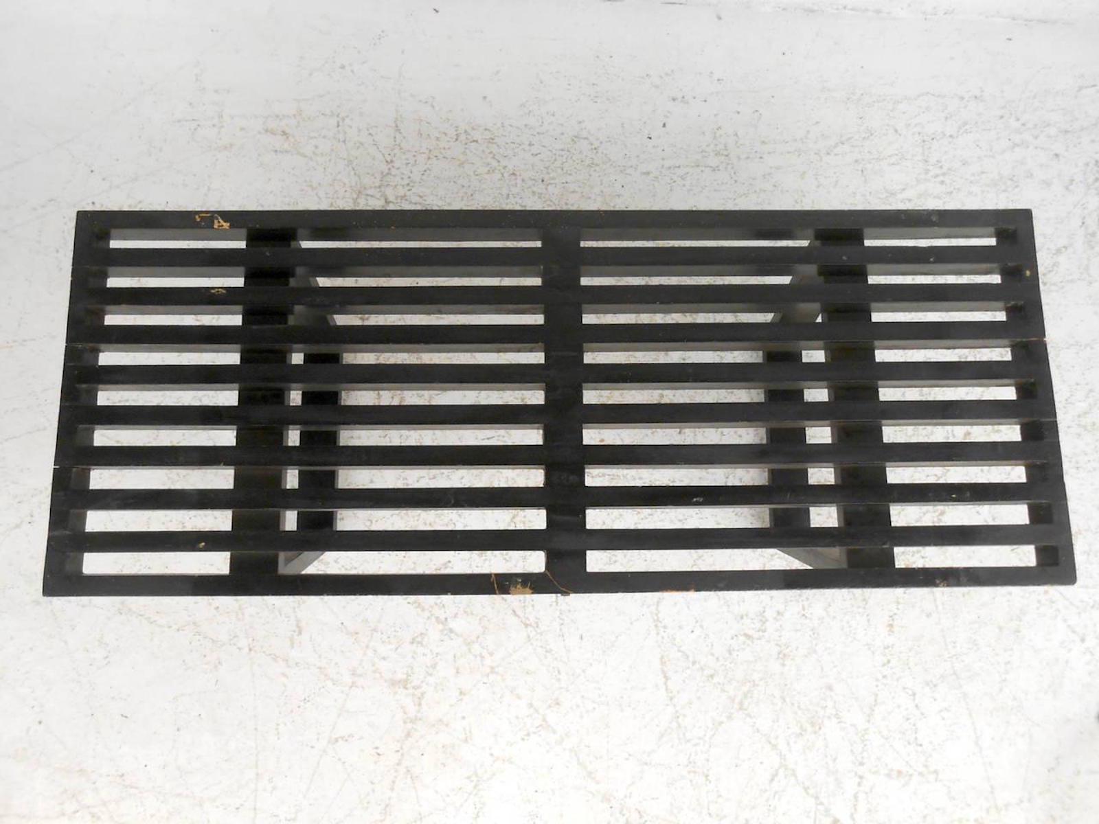 This compact midcentury slat bench by George Nelson features a compact size and a black painted finish which offer a bold modern accent to any home or office space. 
(Please confirm item location - NY or NJ - with dealer).
  