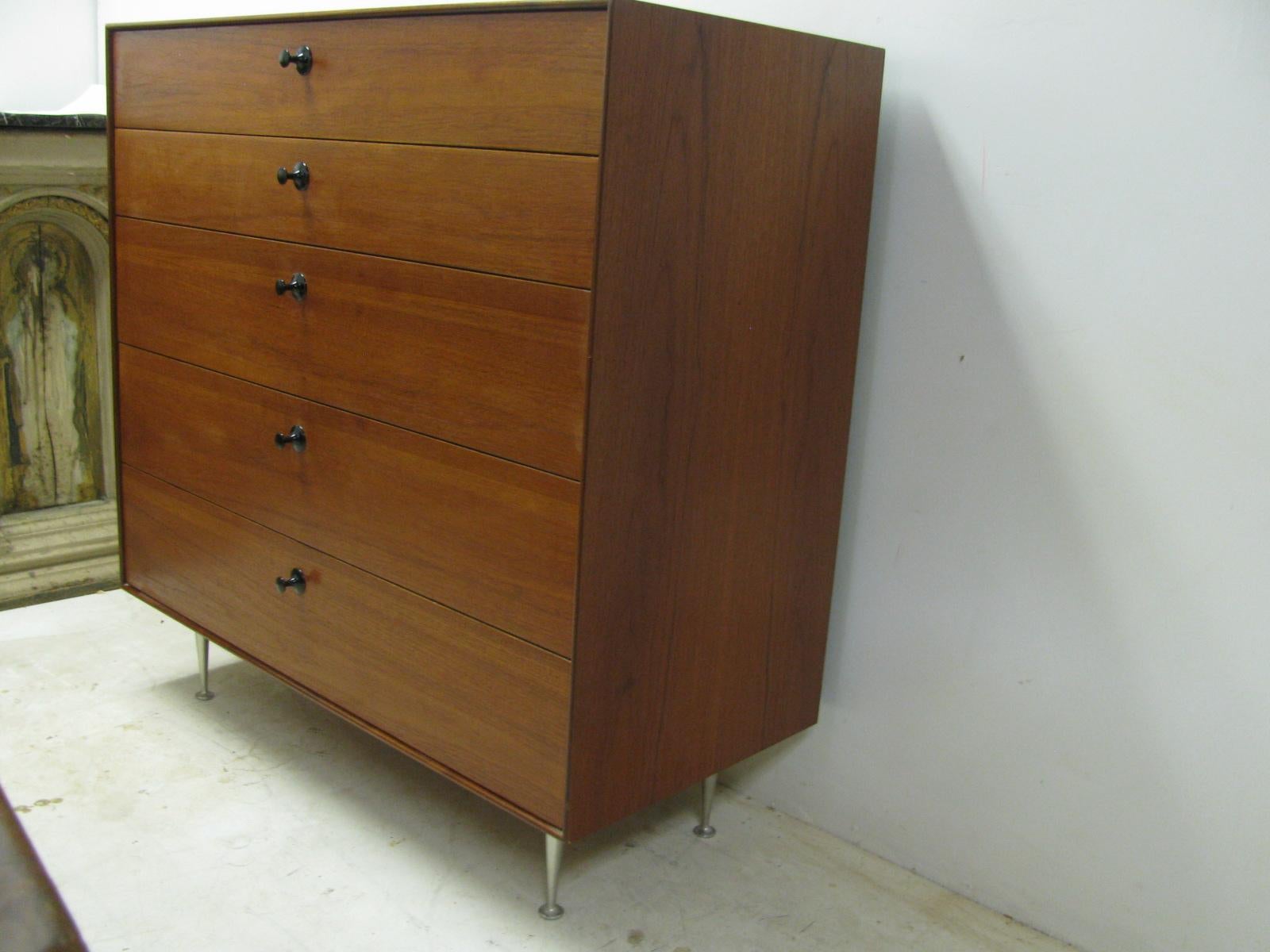 Beautiful design by George Nelson for Herman Miller. Five-drawer teak chest on aluminium legs with black enameled pulls. Has drawer separate compartment dividers which can be taken out. In excellent vintage condition with minimal wear.