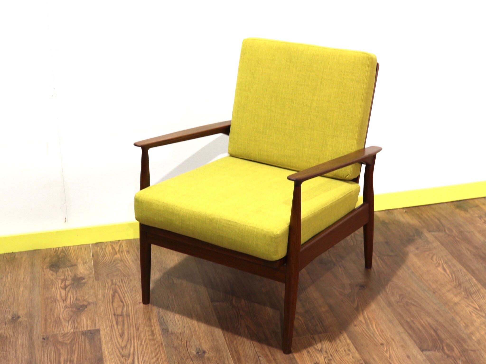 A beautiful lounge chair made by British make George Stone. A stunning piece of furniture with gorgeous lines and vibrant yellow upholstery this is a stunning chair.