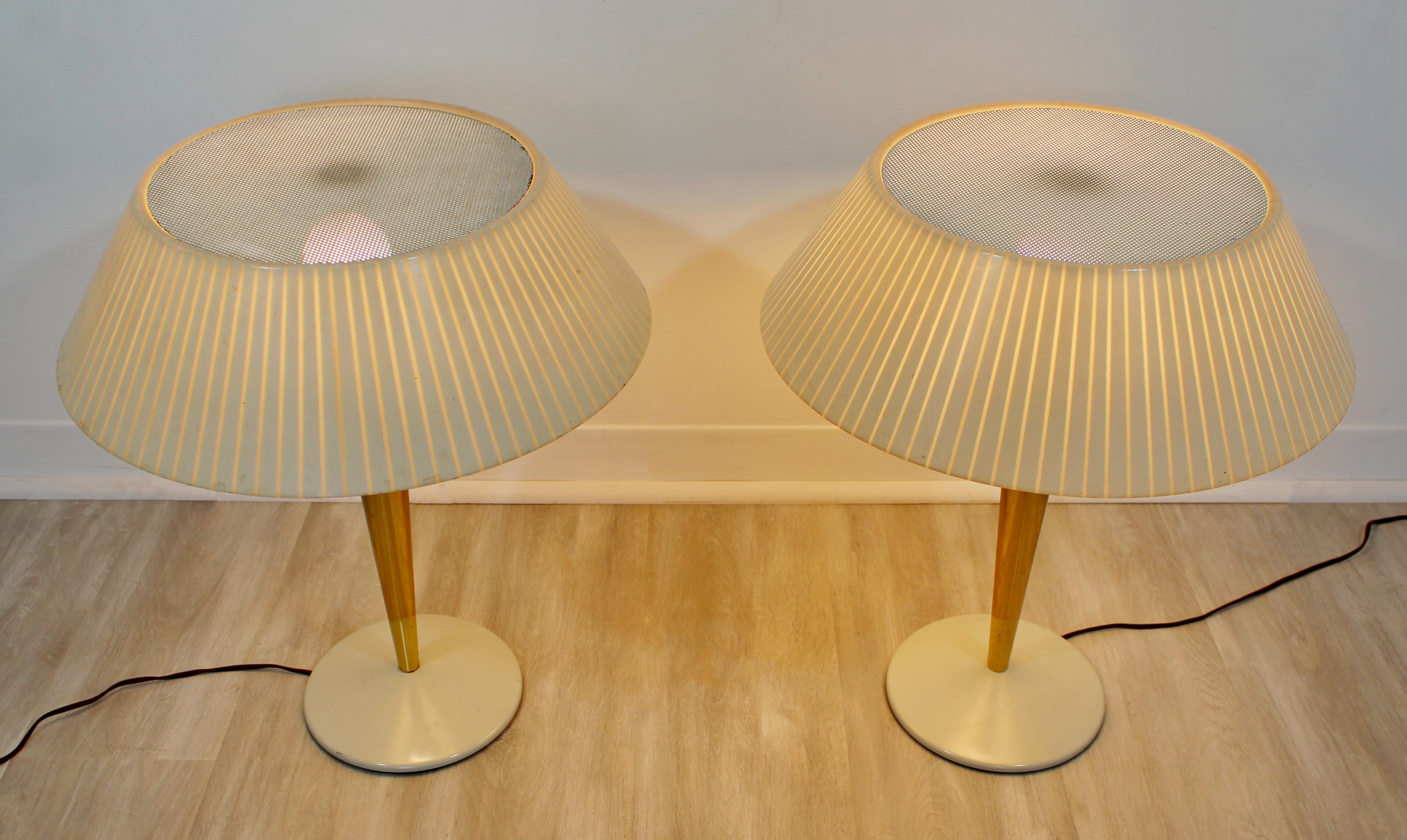 For your consideration is a fabulous pair of brass table lamps, designed by Gerald Thurston for Lightolier, circa the 1960s. In very good condition, with a patina to match age and use. The dimensions are 18