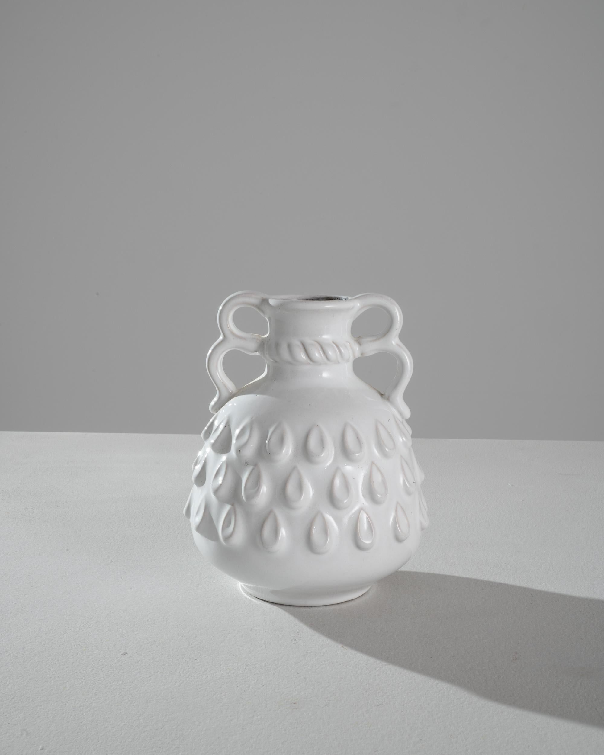 A unique shape gives this ceramic vase an intriguing character and an easy-going charm. Made in Germany in the 20th century, the silhouette is complex yet visually soothing: full curves and serpentine lines combine natural forms with artful