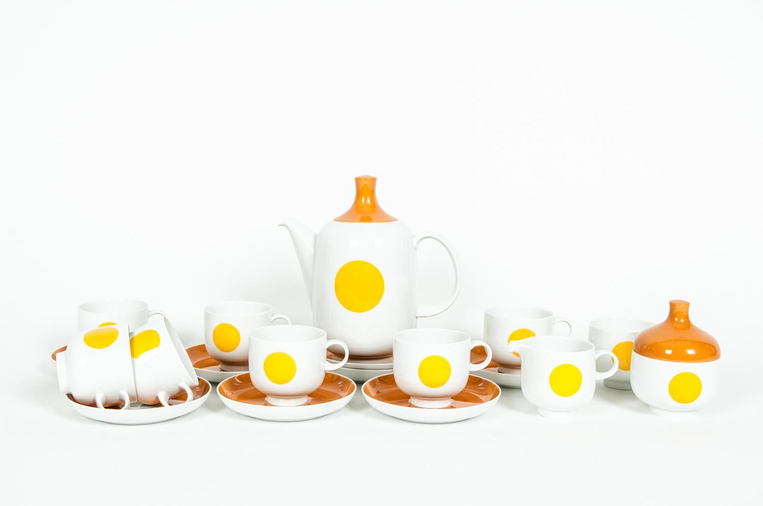 Mid-Century modern German porcelain tea / coffee service for eight people. Each piece is in excellent condition, maker's mark undersigned. The tea / coffee pot is about 8.5 inches x 8 inches diameter. Sugar bowl is 4.5 inches x 4 inches. Creamer is