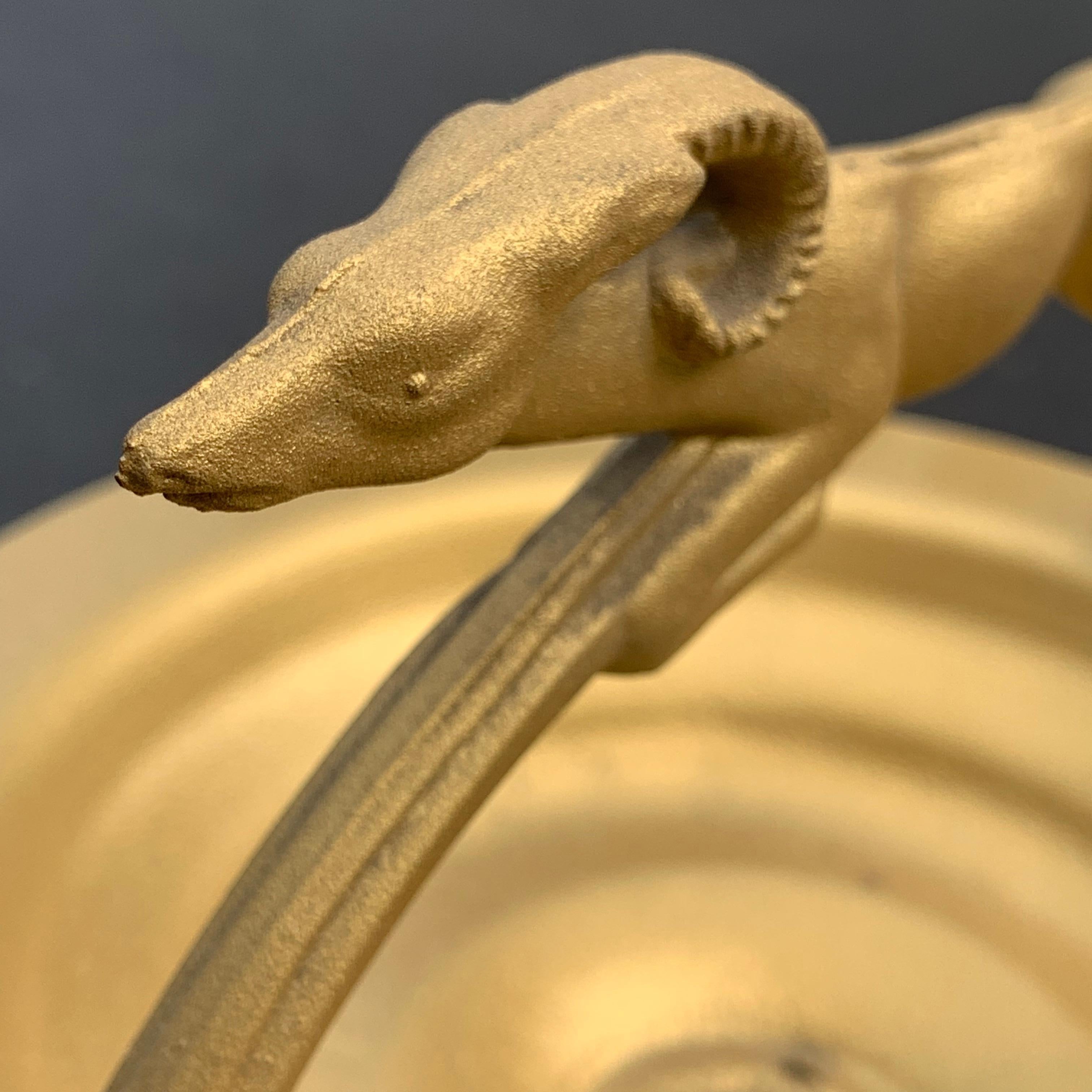 Mid-Century Modern gilded iron ram ashtray. Feast your eyes on this beautiful golden tall floor ashtray. Even if you are not a smoker, this beautiful cast iron floor statue is graced with a greyhound at the top and is as comfortable holding