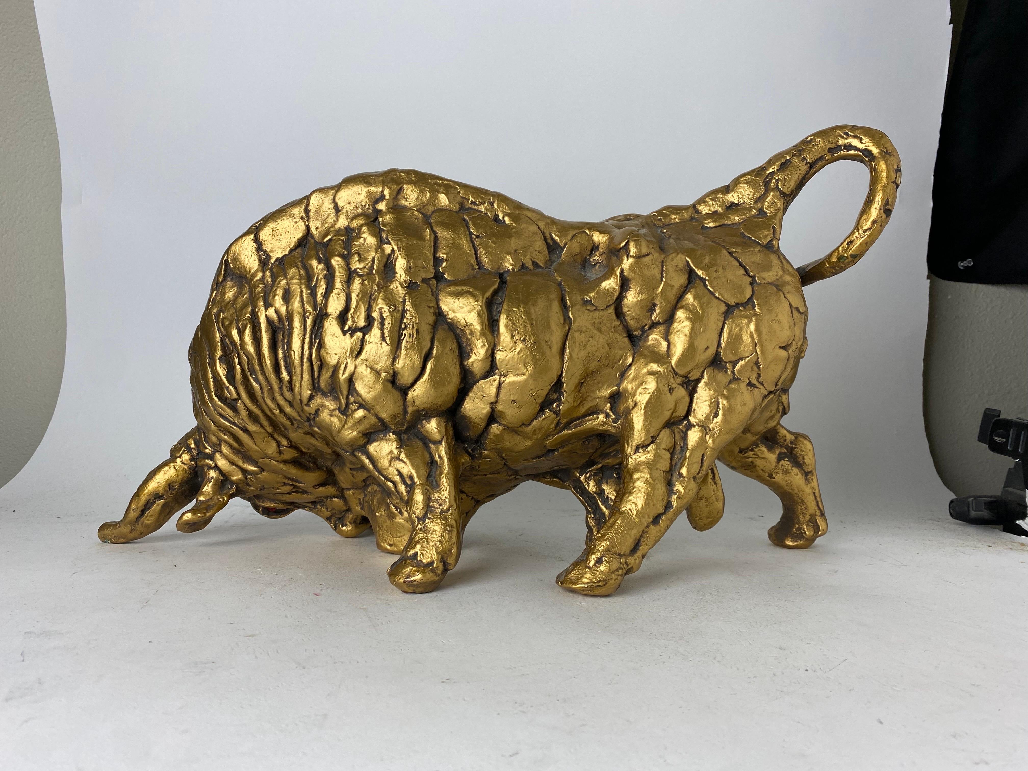 Nous vous proposons une magnifique sculpture en céramique dorée représentant un taureau en train de charger. À la fois vivant et artistique, ce taureau montre sa force et sa colère, prêt à s'en prendre à vous. La statue de taureau est complétée par