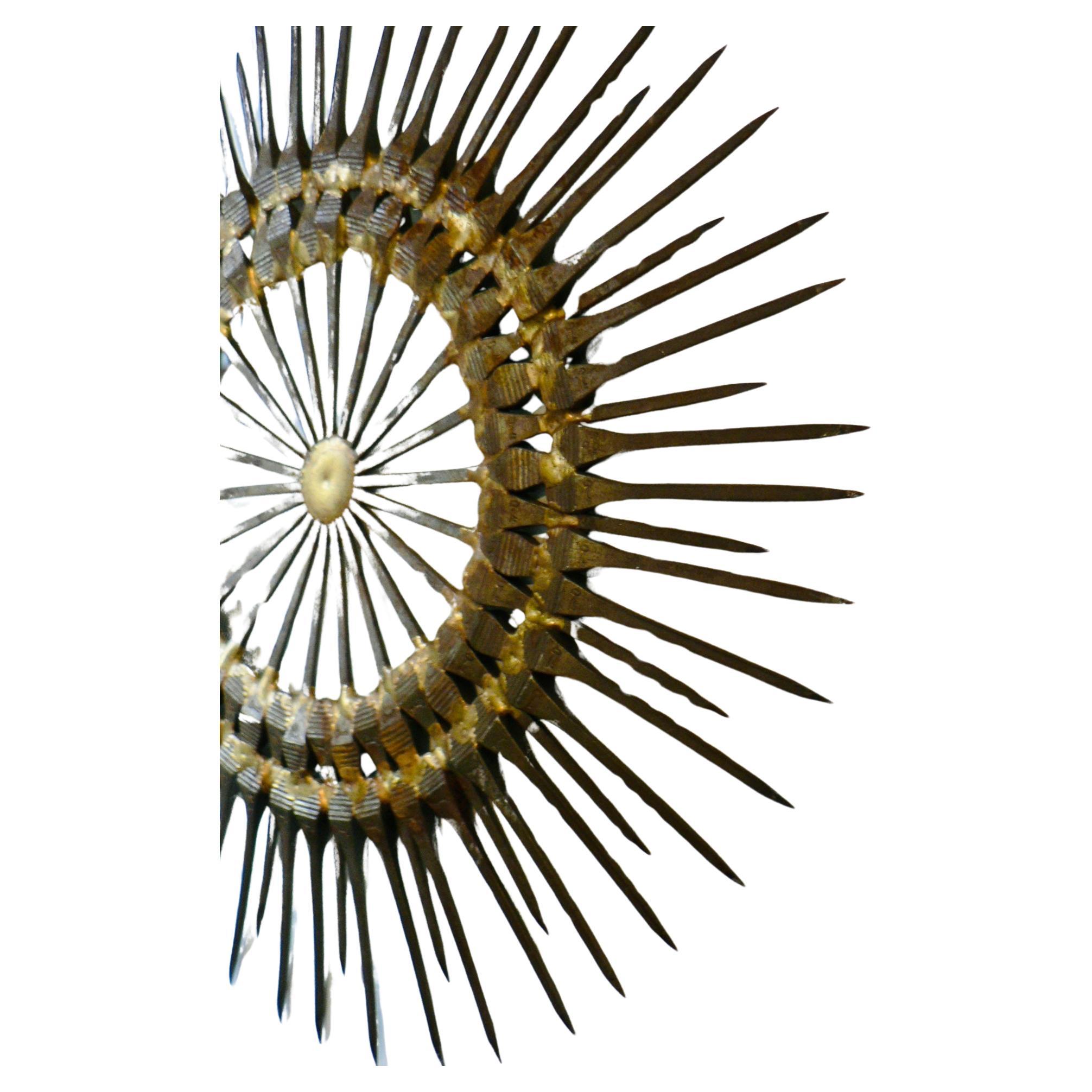 Impressive two-tiered starburst wall sculpture in iron nail in the Brutalist style. Attributed to William Bowie, American artist circa 1970, though unsigned. Truly a living piece of art, a nova perpetually exploding on your wall.

This piece had a