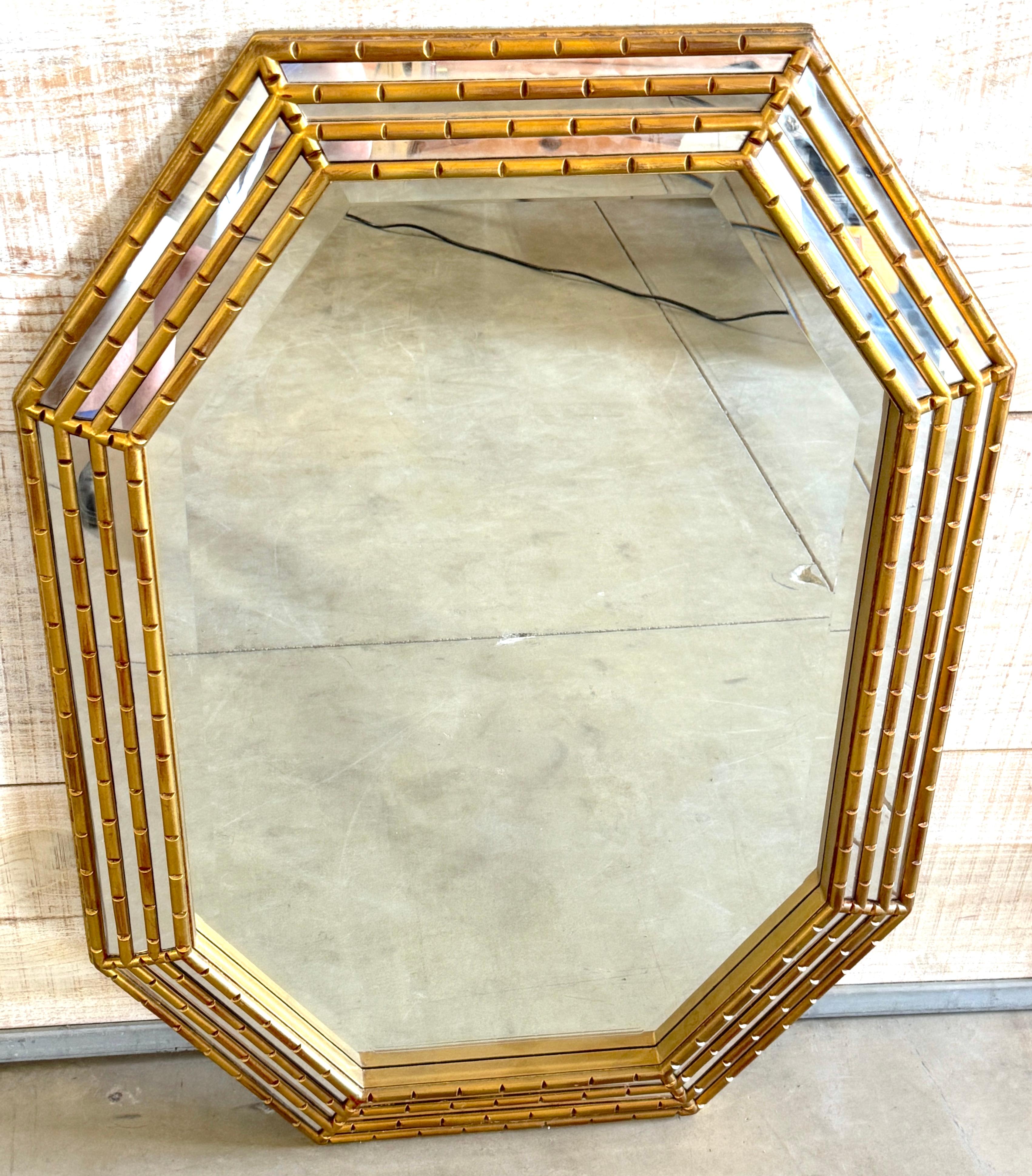 Mid-Century Modern Gilt-Lacquered Geometric Beveled Mirror

A striking Mid-Century Modern gilt-lacquered mirror featuring a bold octagonal geometric frame with a triple-tiered faux-bamboo design. The warm gold finish is subtly distressed, evoking an