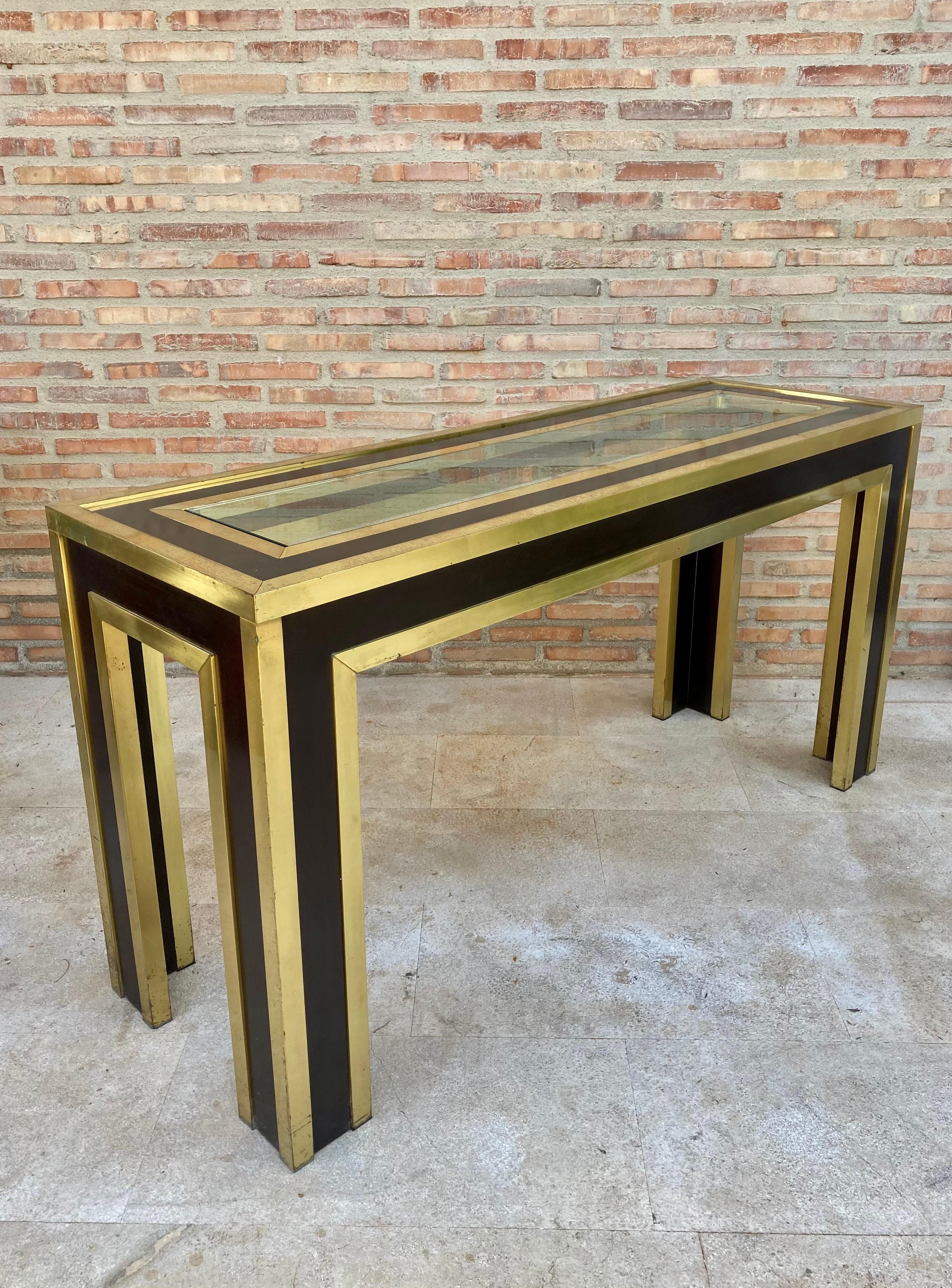 Console design 1970 in wood, glass and gold aluminium structure.

Mid-century brass, wood, gilt aluminum and glass console.
The top of this console is made of glass.
It is in good condition.
This elegant console is perfect to decorate a wide