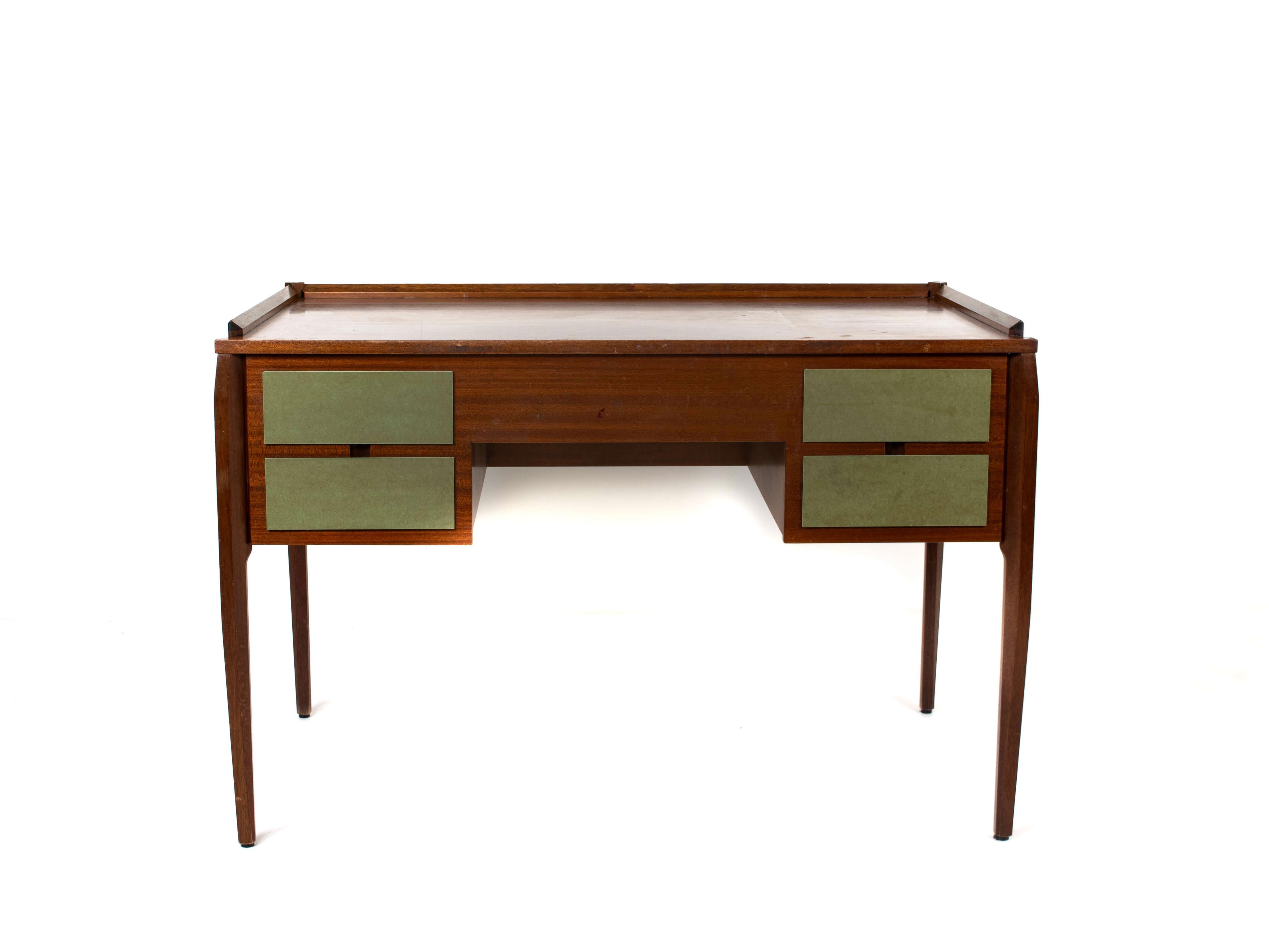 Italian Mid-Century Modern writing desk by Gio Ponti for Dassi from the 1960s. This desk is made out of mahogany veneer with the front drawers laminated in green. The desk has a minimal and functional design. This desk is very practical and has the