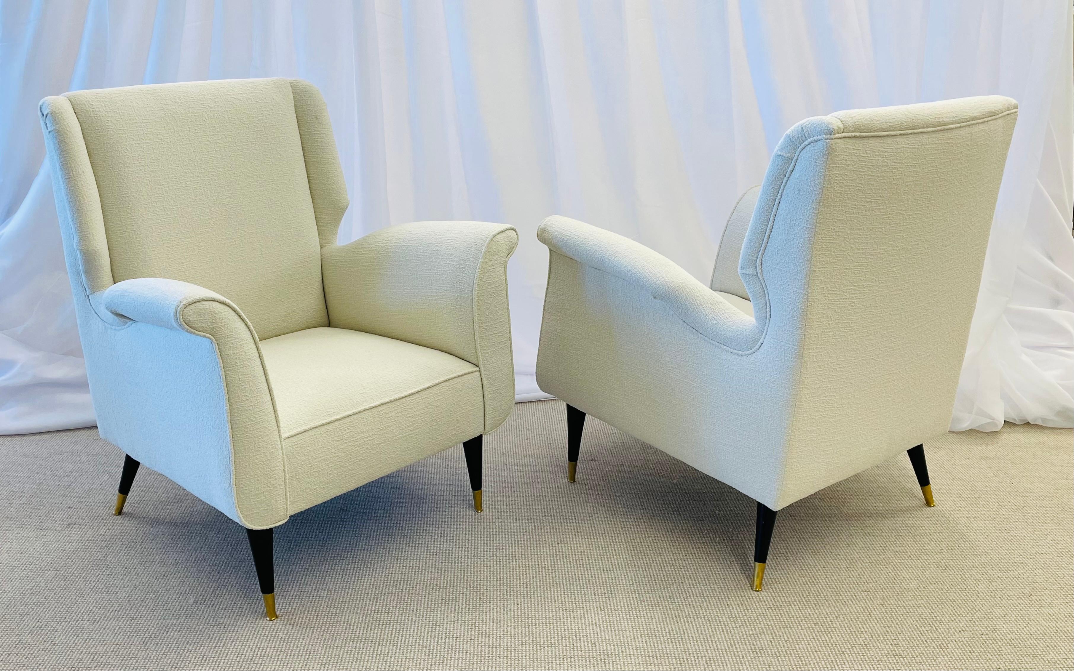 Mid-Century Modern Gio Ponti Style Armchairs, Wingback Chairs, Pair in Kravet Bouclé
 
These finely detailed sleek and stylish armchairs depict this iconic designer’s style for flair and simplicity at his highest level. The tapering mahogany legs