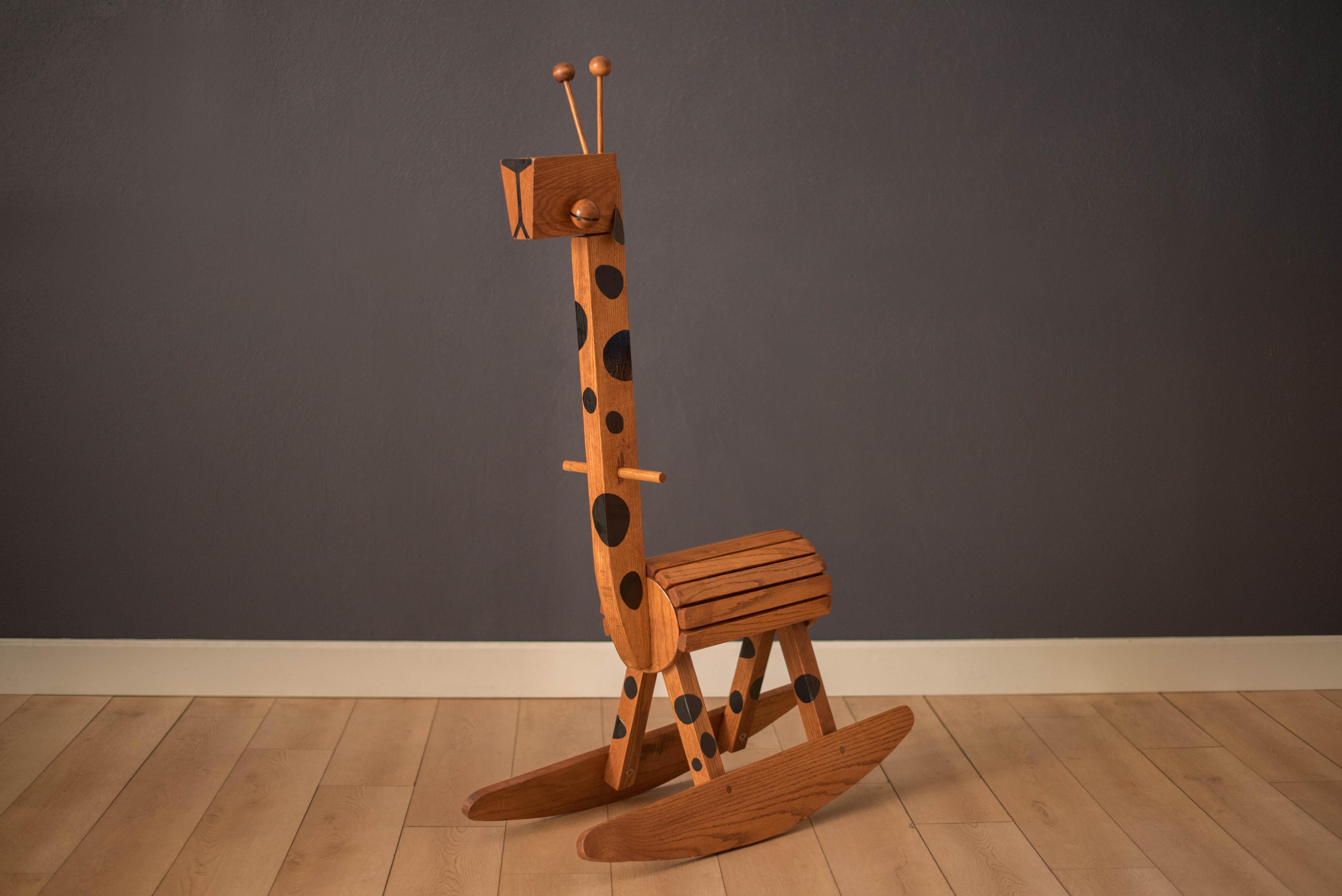 Mid century giraffe rocking toy chair manufactured by Kaboodle Kit, circa 1960s. This unique decorative piece is built with a sturdy oak frame and includes the original wood dowel handles and leather ears. Perfect for a nursery or playroom. 


