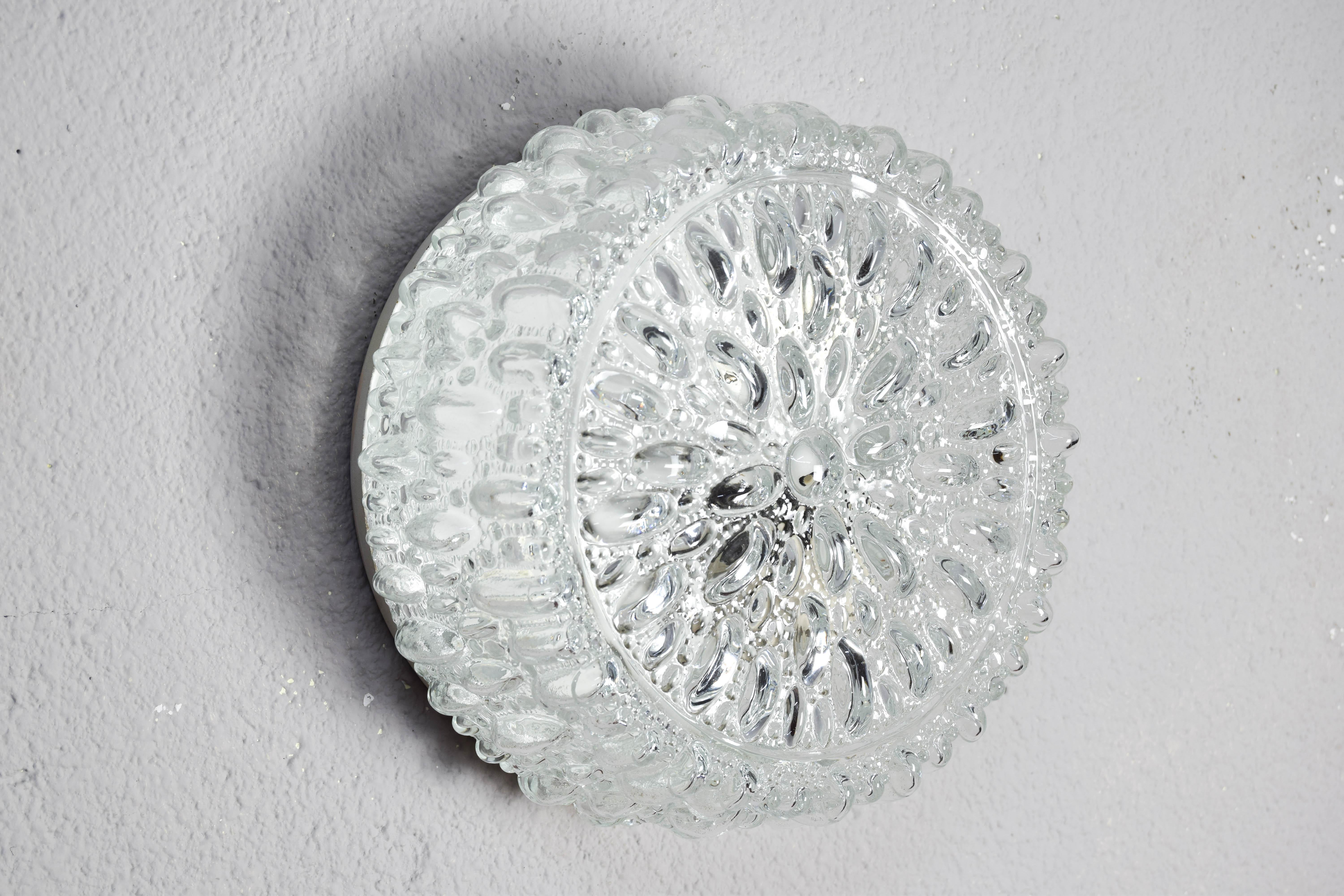 Vintage flush mount ceiling light designed and manufactured by Glashütte Limburg 1960s. 26 cm in diameter, 11 cm high.
This 1960's glass flush mount light can also be used as a wall sconce.

The lamp is made of thick, heavy crystal glass with a
