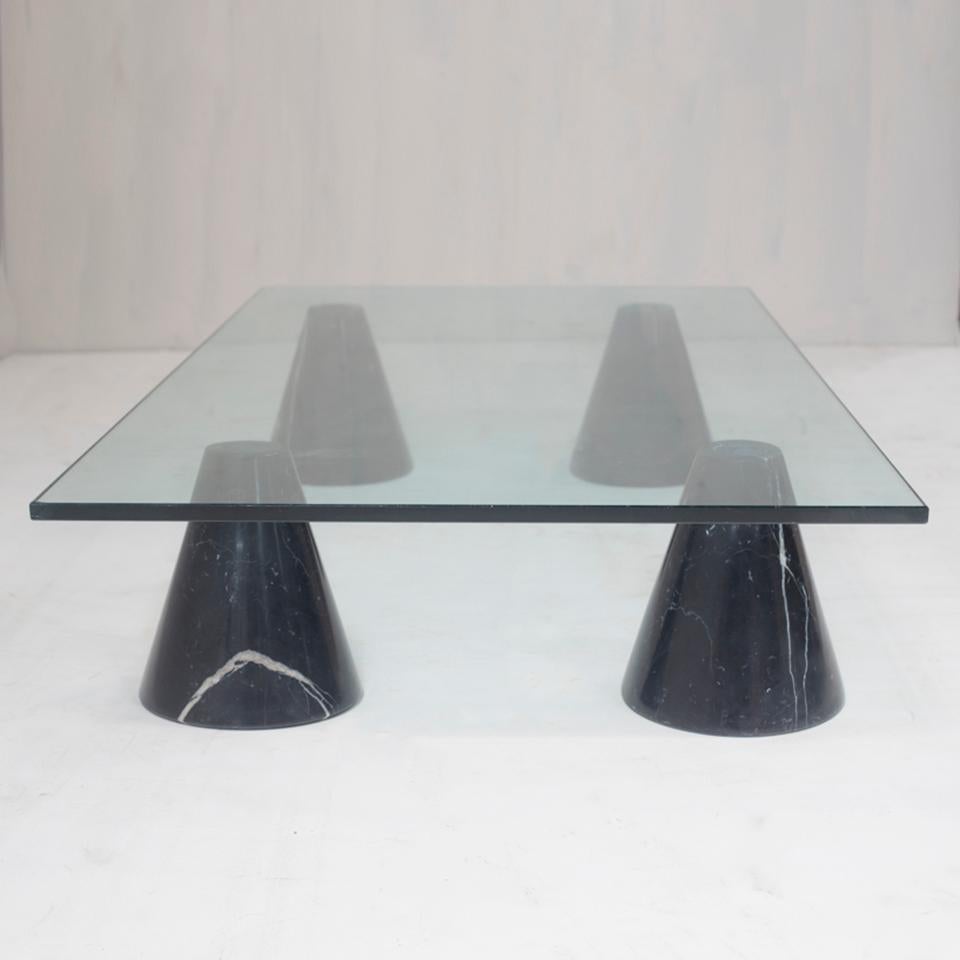 Glass top coffee table with cone-shaped black marble legs from Italy.
The top and legs are not glued-on. Simple design.