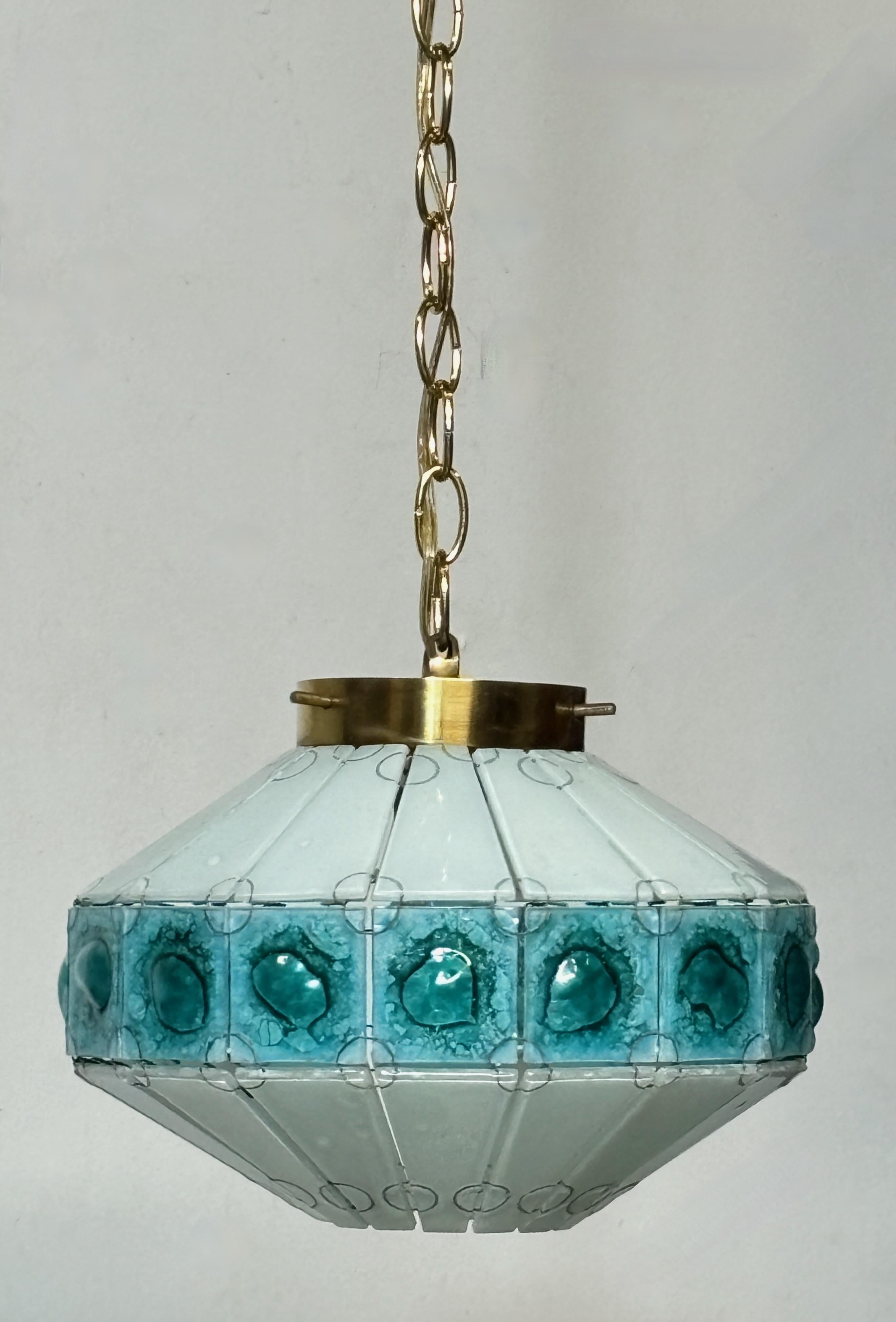 Mid Century glass pendant light fixture with brass hardware.
The length with the chain measures 47 inches. We can shorten to buyers specifications if desired. The height of  the glass (not including the hanging chain) is 9 inches.
Recently re-wired