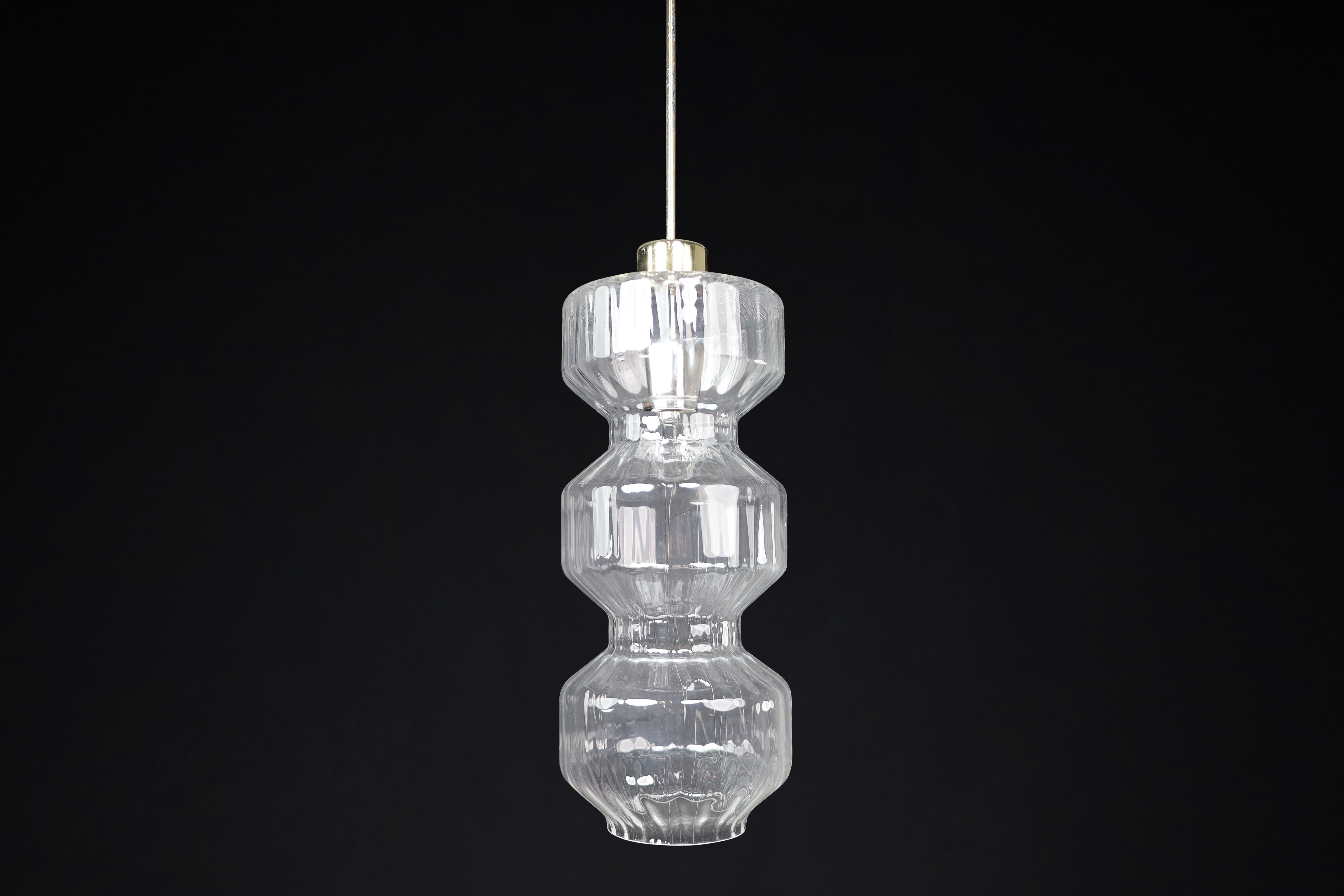 Mid-Century Modern Glass and Brass Pendants, Bohemia, Czechoslovakia, 1970s (10 Available, Priced per Pendant)

Description:

These elegant Mid-Century Modern pendants were produced in Bohemia, Czechoslovakia during the 1970s—an era and region