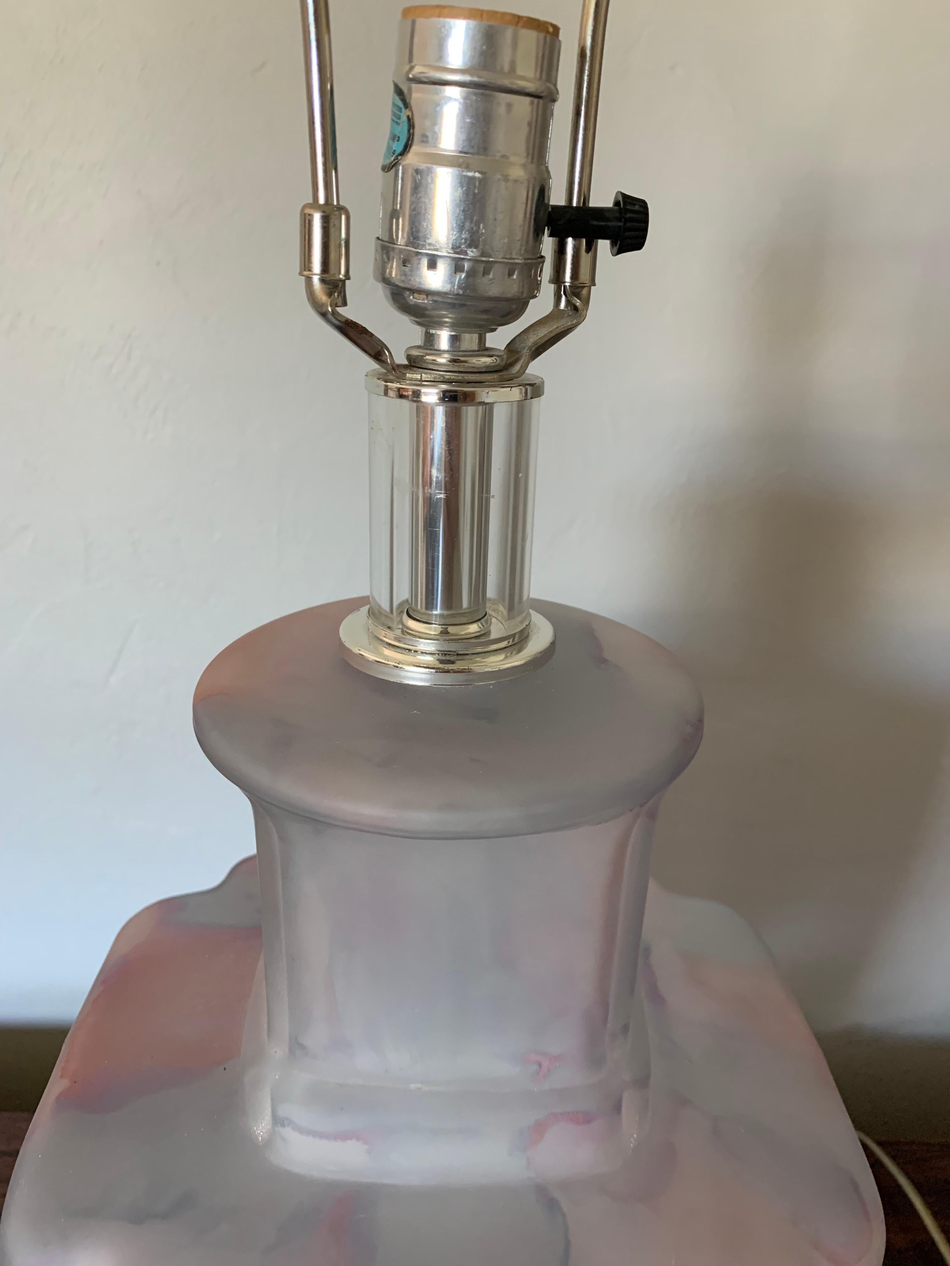 Fantastic pair of Mid century modern Bauer table lamps. Beautifully made from swirling glass with pinks, whites, blues and clear glass. Lucite base and finial with chrome accents.

Has a light in the glass as well for a second source of light.