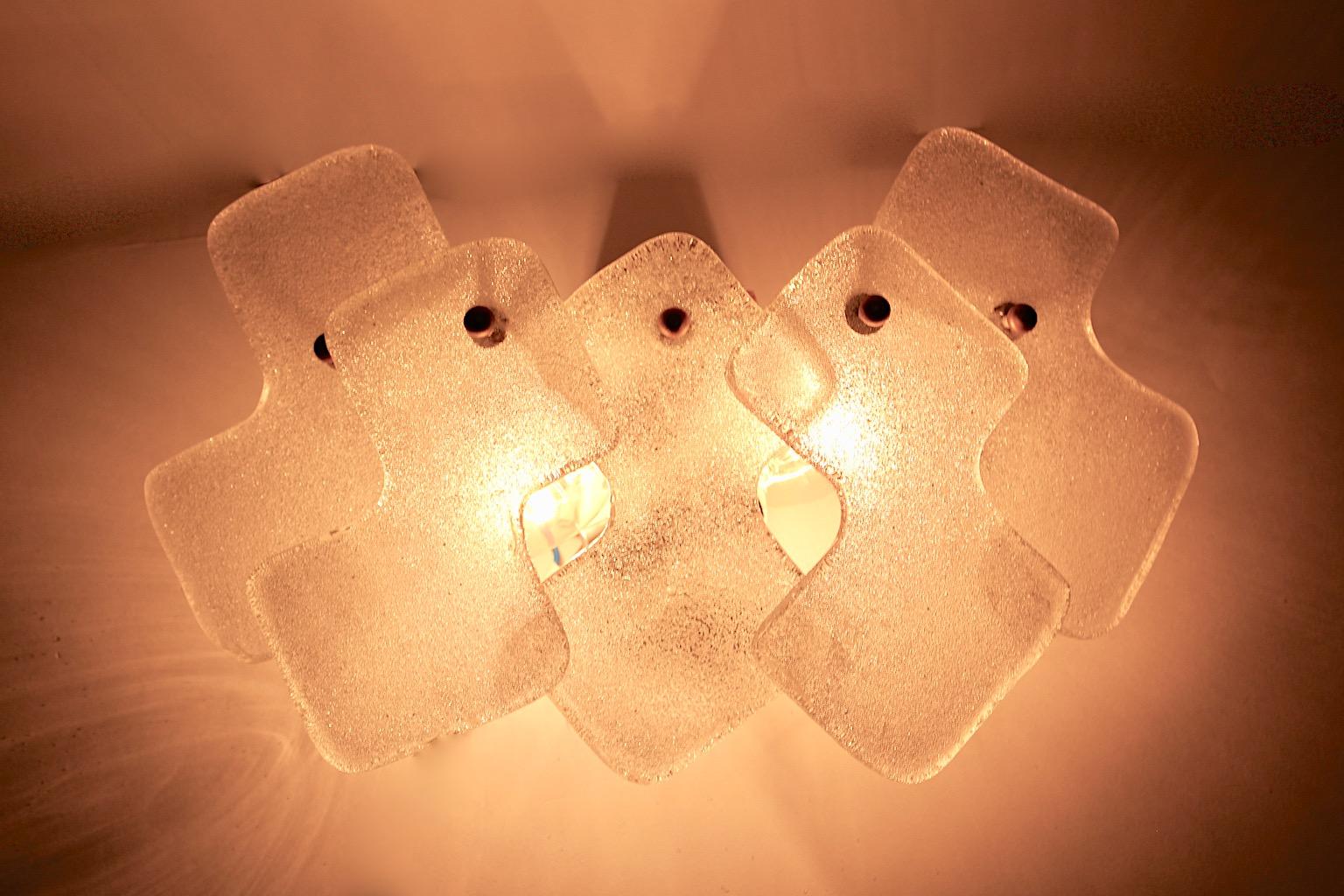 Mid-Century Modern vintage white glass sconce or wall light designed and manufactured by J. T. Kalmar, Vienna 1960s.
A beautiful and stunning Mid Century Modern sconce shows geometric soft white glass elements supported by brass ball screws and a