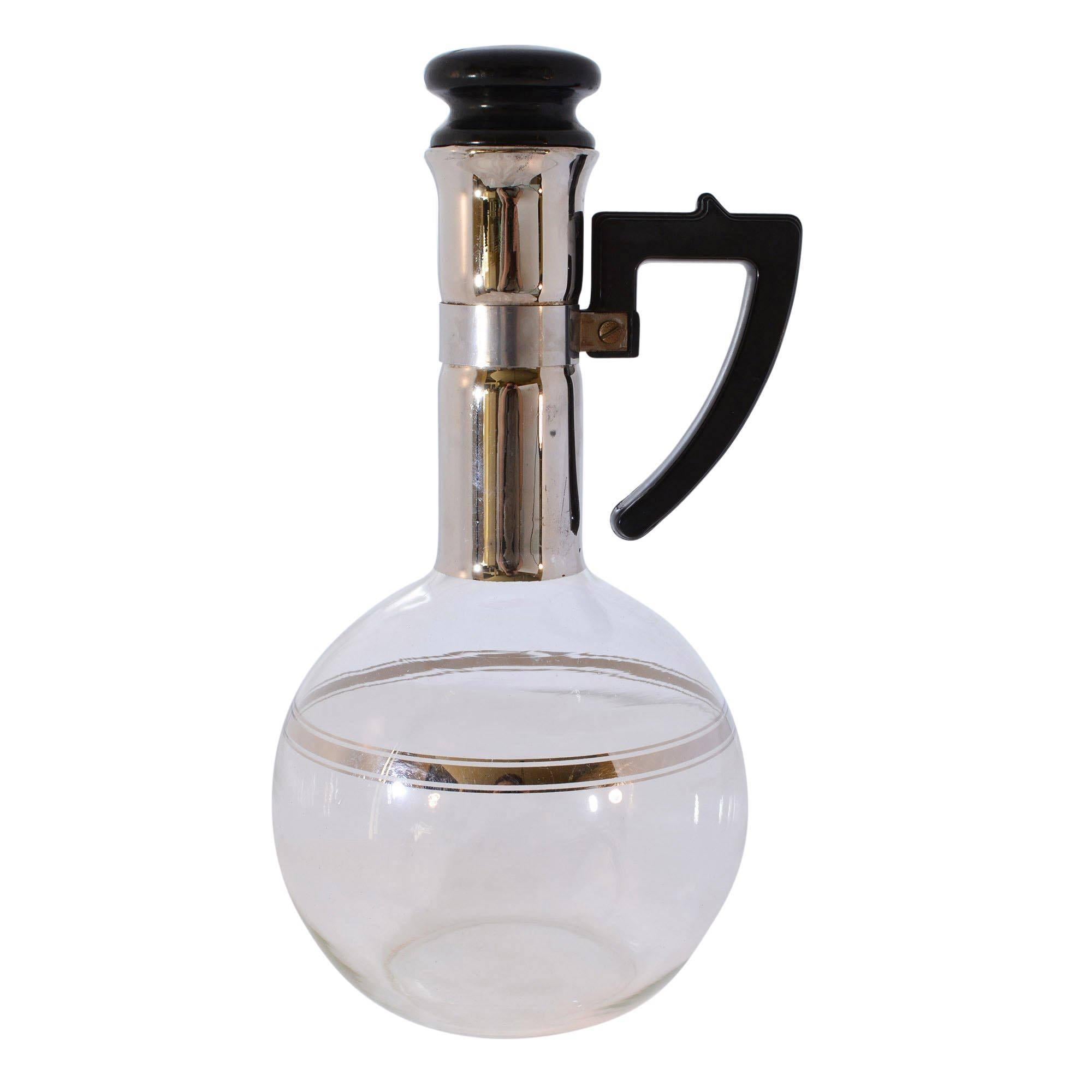 As an avid coffee drinker, this handblown Mid-Century Modern glass decanter caught my attention. What a striking vessel for coffee at a brunch. The long neck has a mirrored finish and is topped with a cork stopper. There is a patent number at the