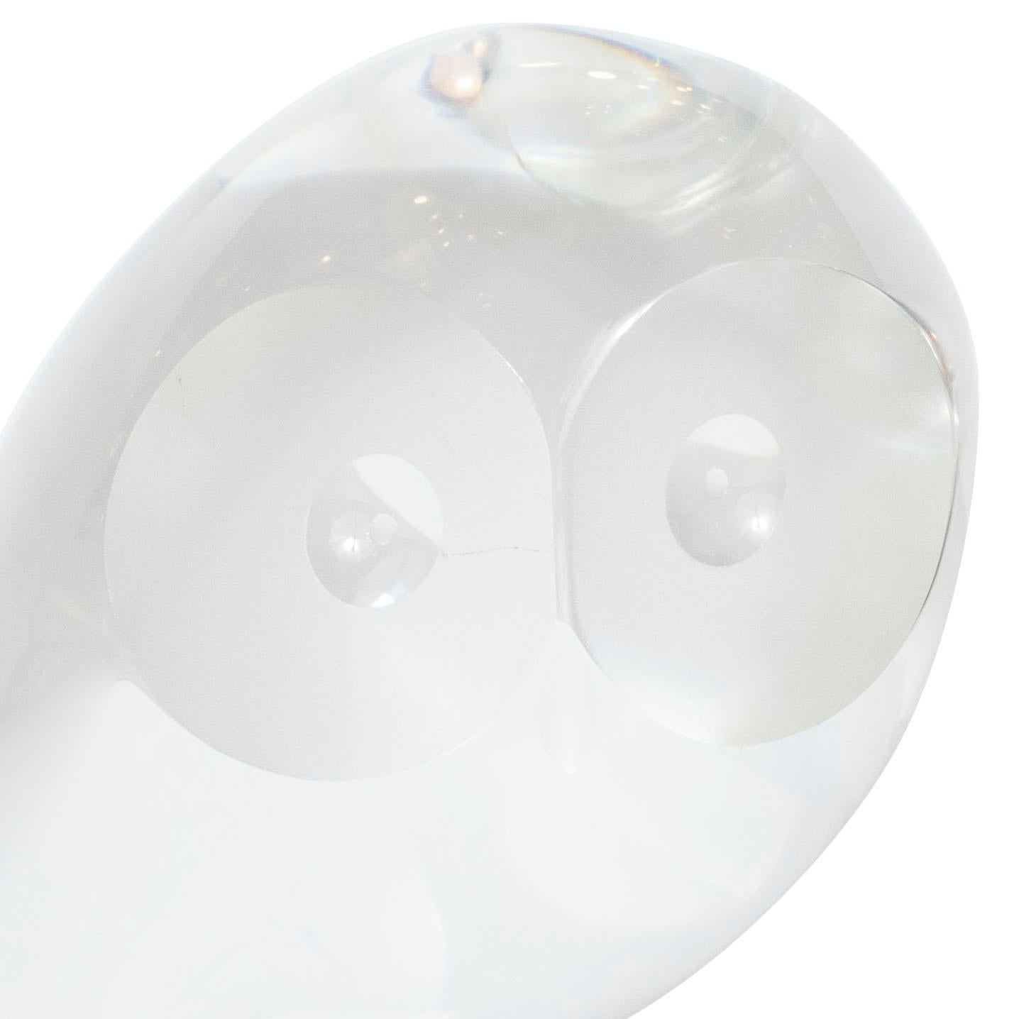 This elegant glass paperweight/decorative object was created by Steuben Glass Works- one of America's premiere glass studios, since its founding in 1903-circa 1960. It offers a highly stylized rendition of a perched owl. Its eyes are depicted as