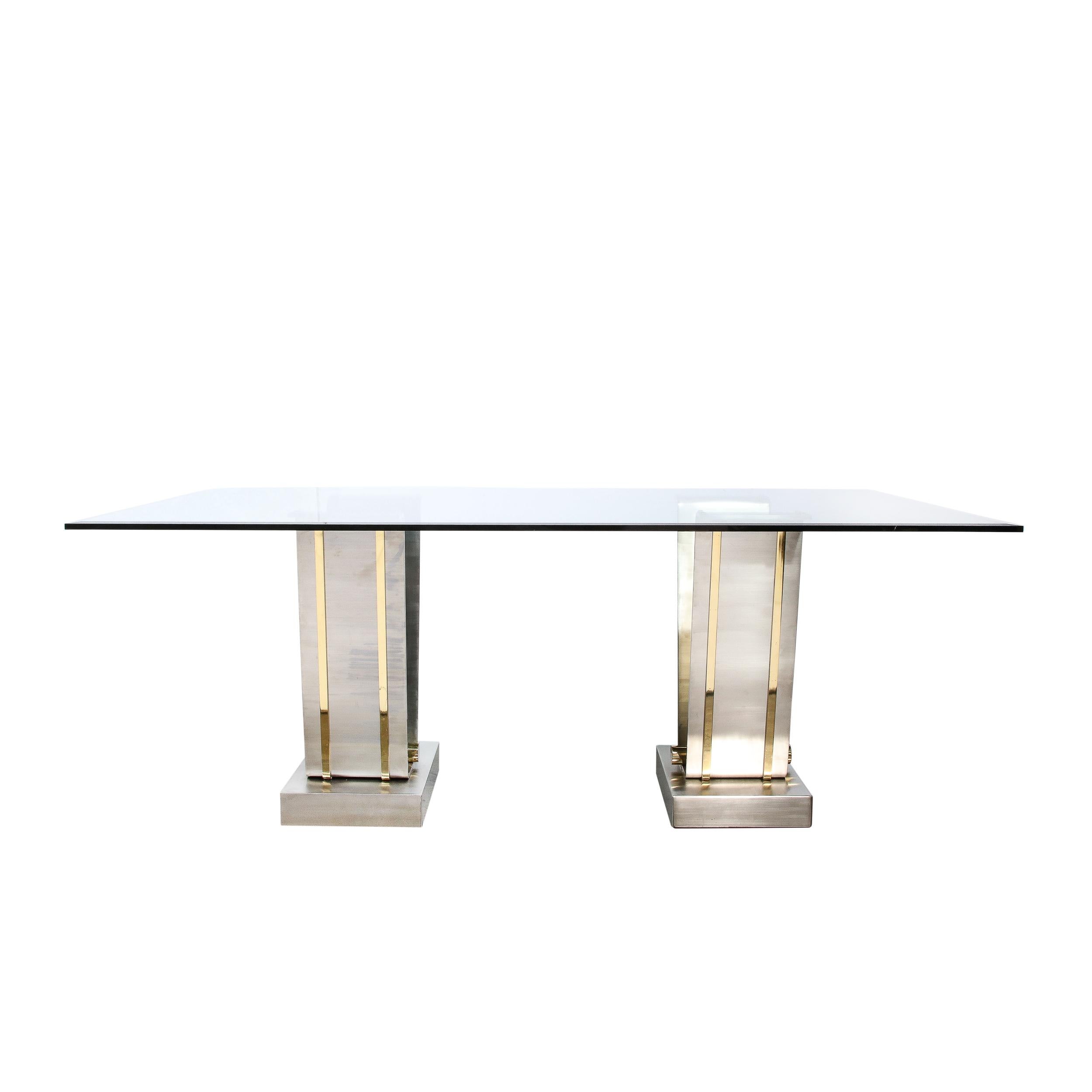 This sleek and elegant Mid-Century Modern table was realized in the United States circa 1970. It features two dramatic V-Form bases in brushed nickel sitting on volumetric rectilinear foundations of the same Material. The rectangular side of the