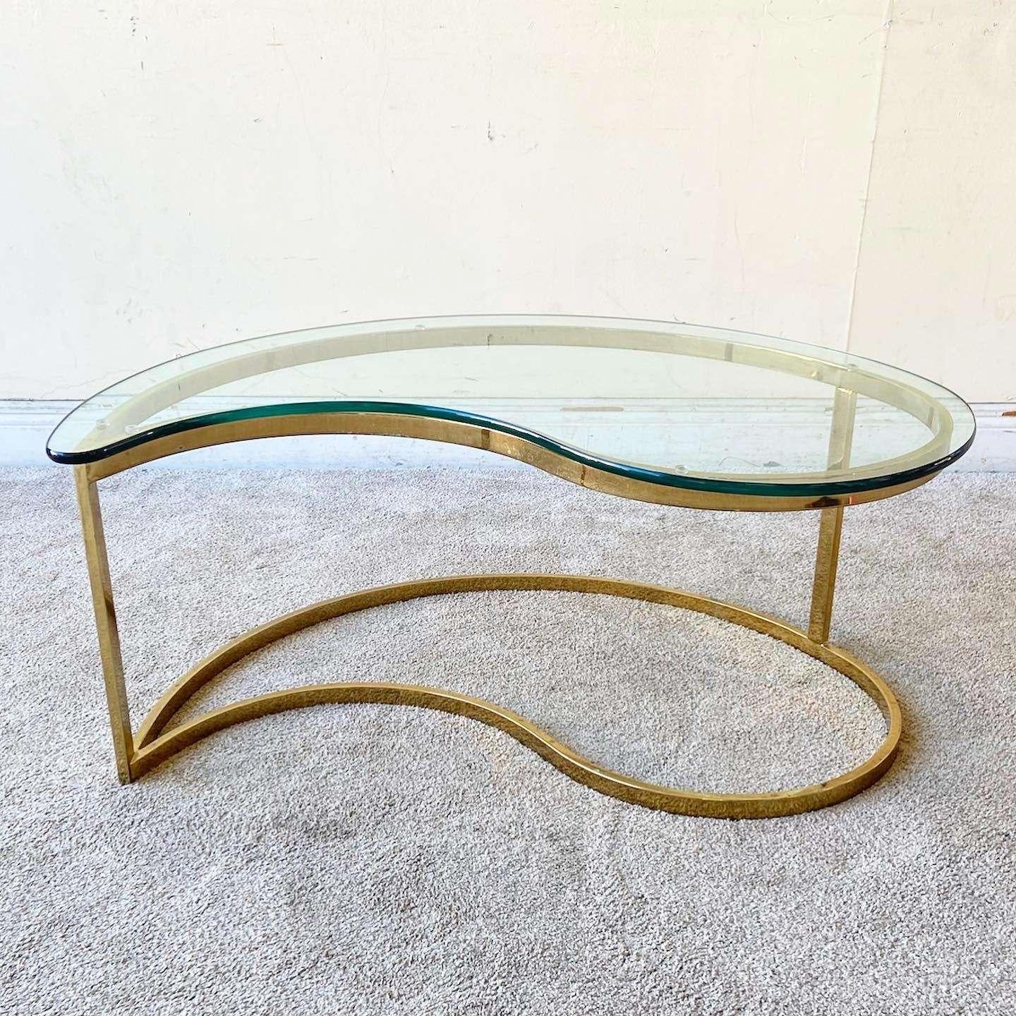 Incredible mid century modern/Hollywood regency glass top coffee table. Glass is cut to a fantastic tear drop shape which sits on the sculpted golden finished base.