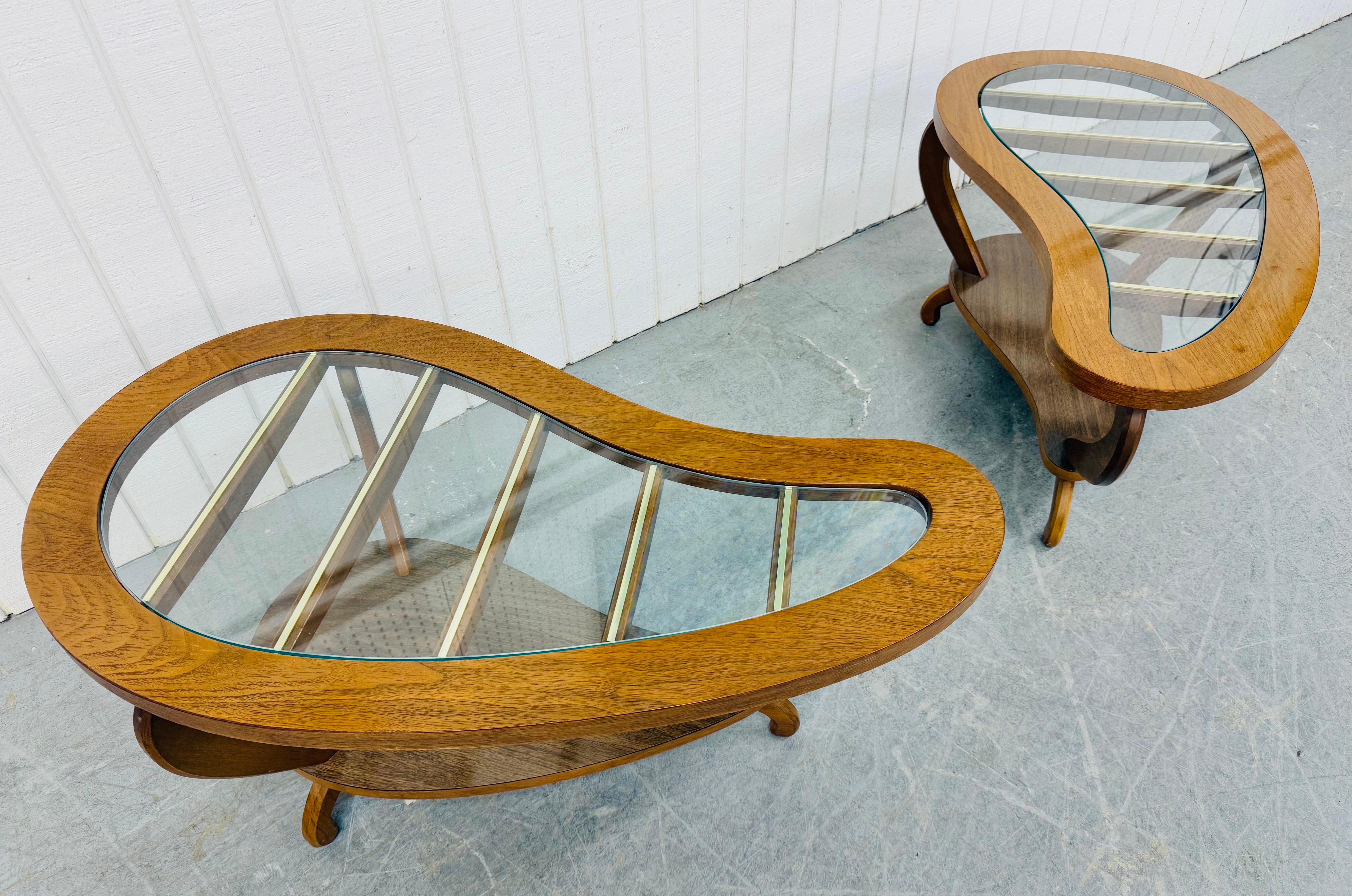 This listing is for a pair of Mid-Century Modern Glass Top Walnut Side Tables. Featuring a tear drop glass top design, laminated bottom storage space, sculpted modern legs, and a beautiful walnut finish. This is an exceptional combination of quality